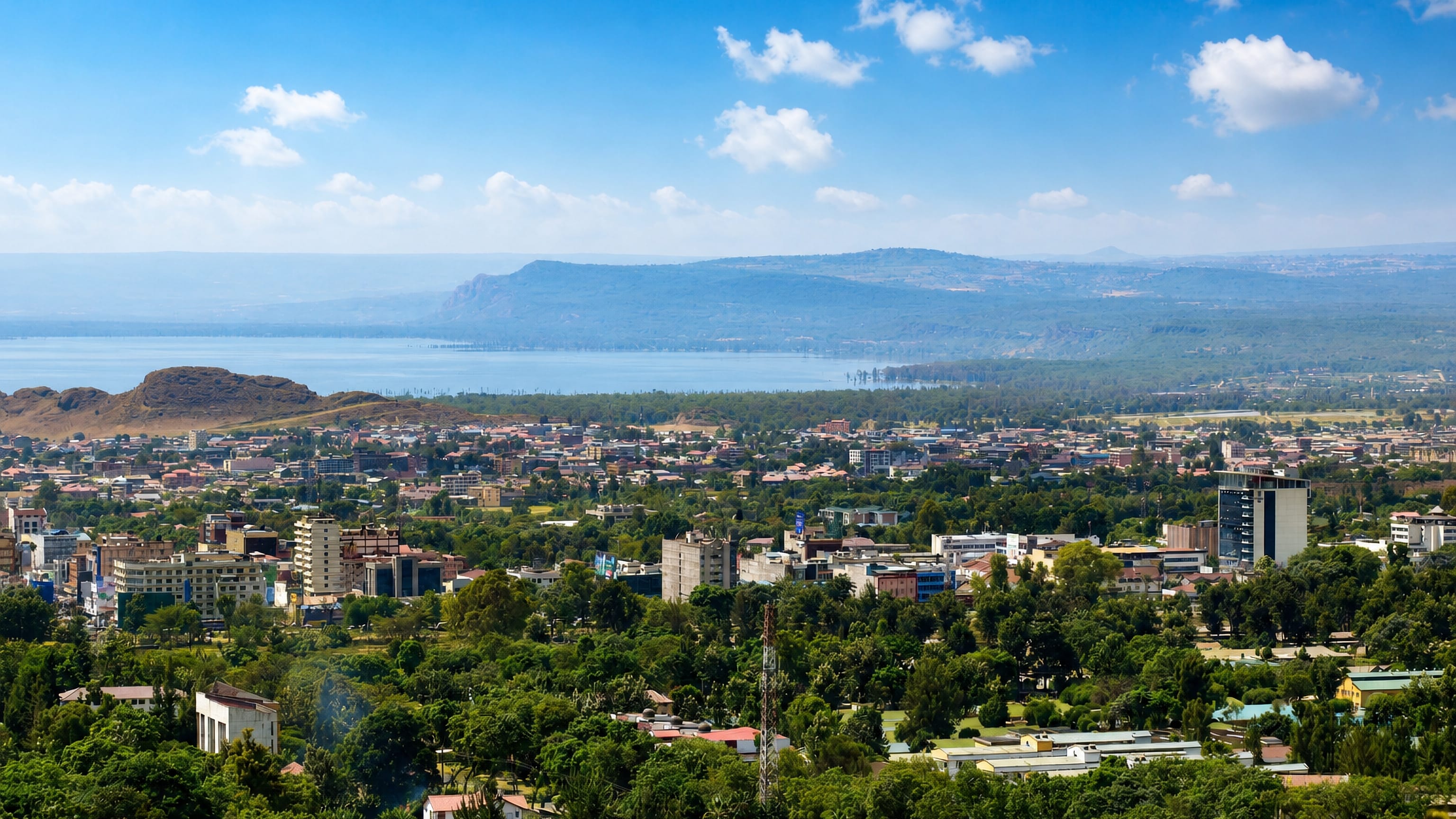 Nakuru, Kenya seen from the hills above, with the town spread below Lake Nakuru and the Rift Valley escarpment