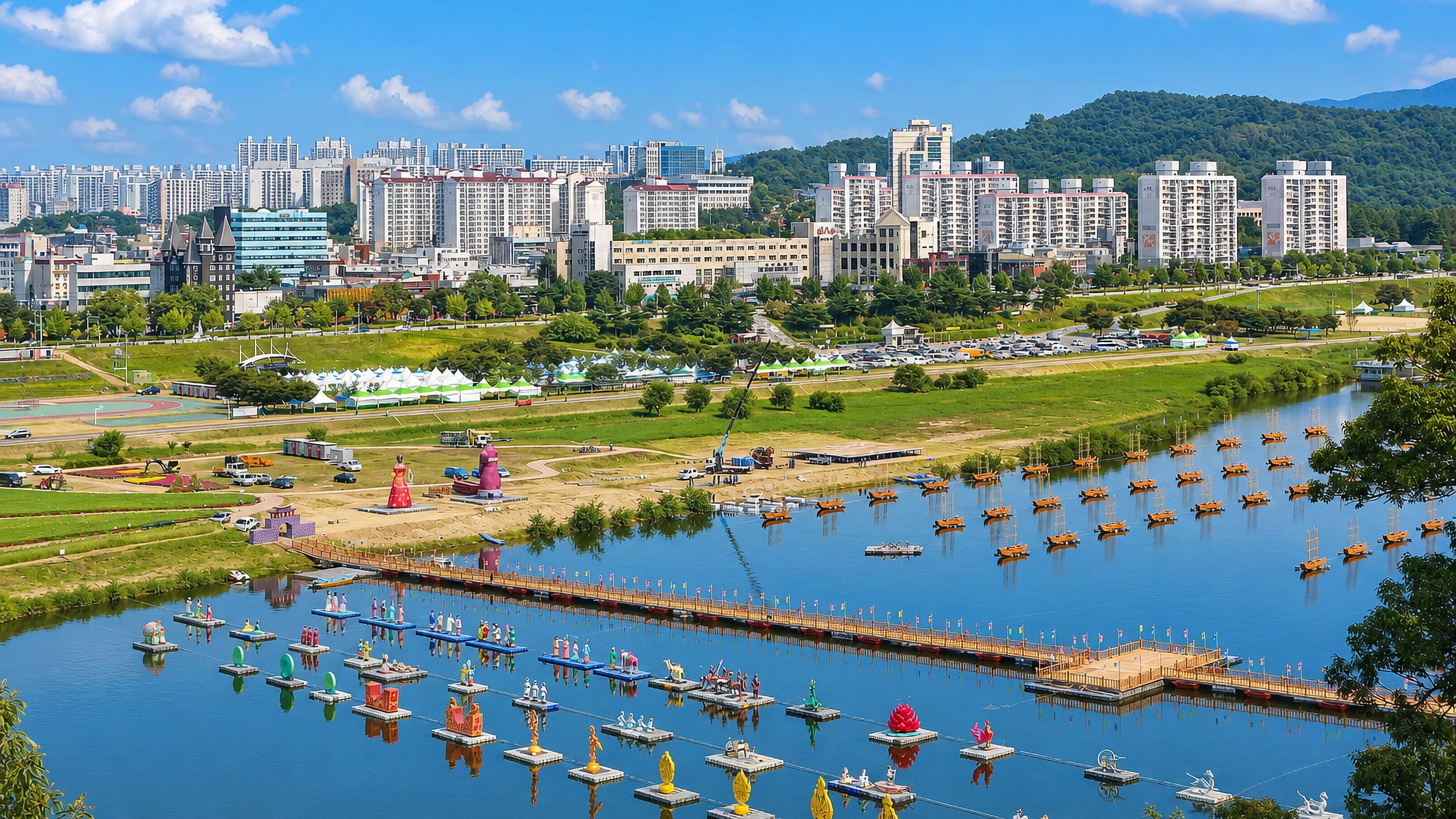 Geumgang riverside at Gongju, South Korea, with festival floats, a pontoon bridge and apartment blocks.