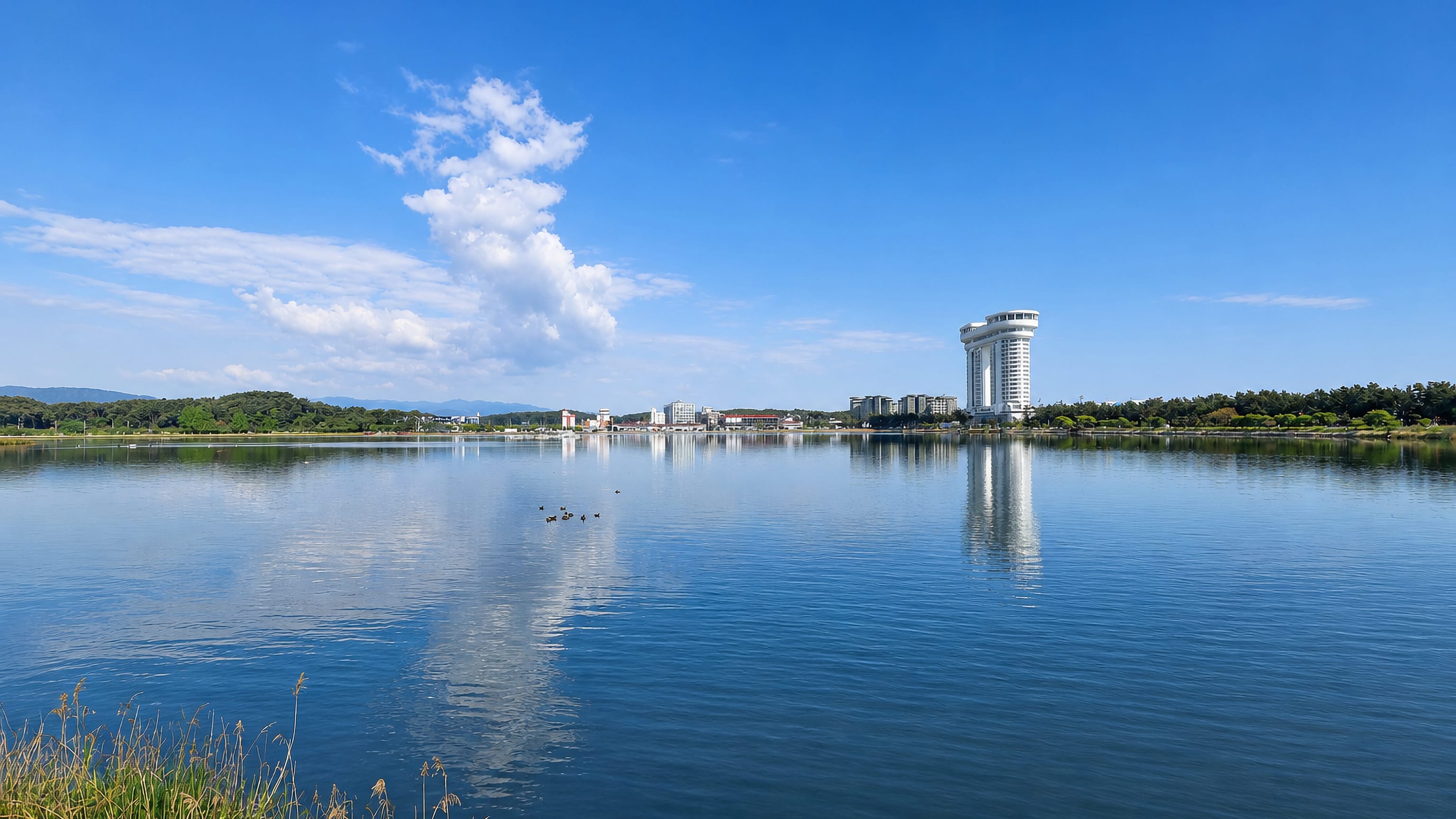 Gyeongpo lagoon at Gangneung reflecting the curved white tower hotel standing on its far shore