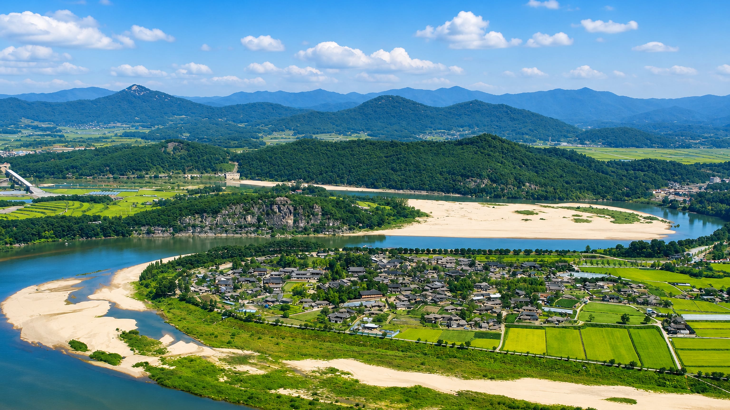 The Nakdong River loops around Andong's tiled-roof Hahoe village, sandbanks and green hills.