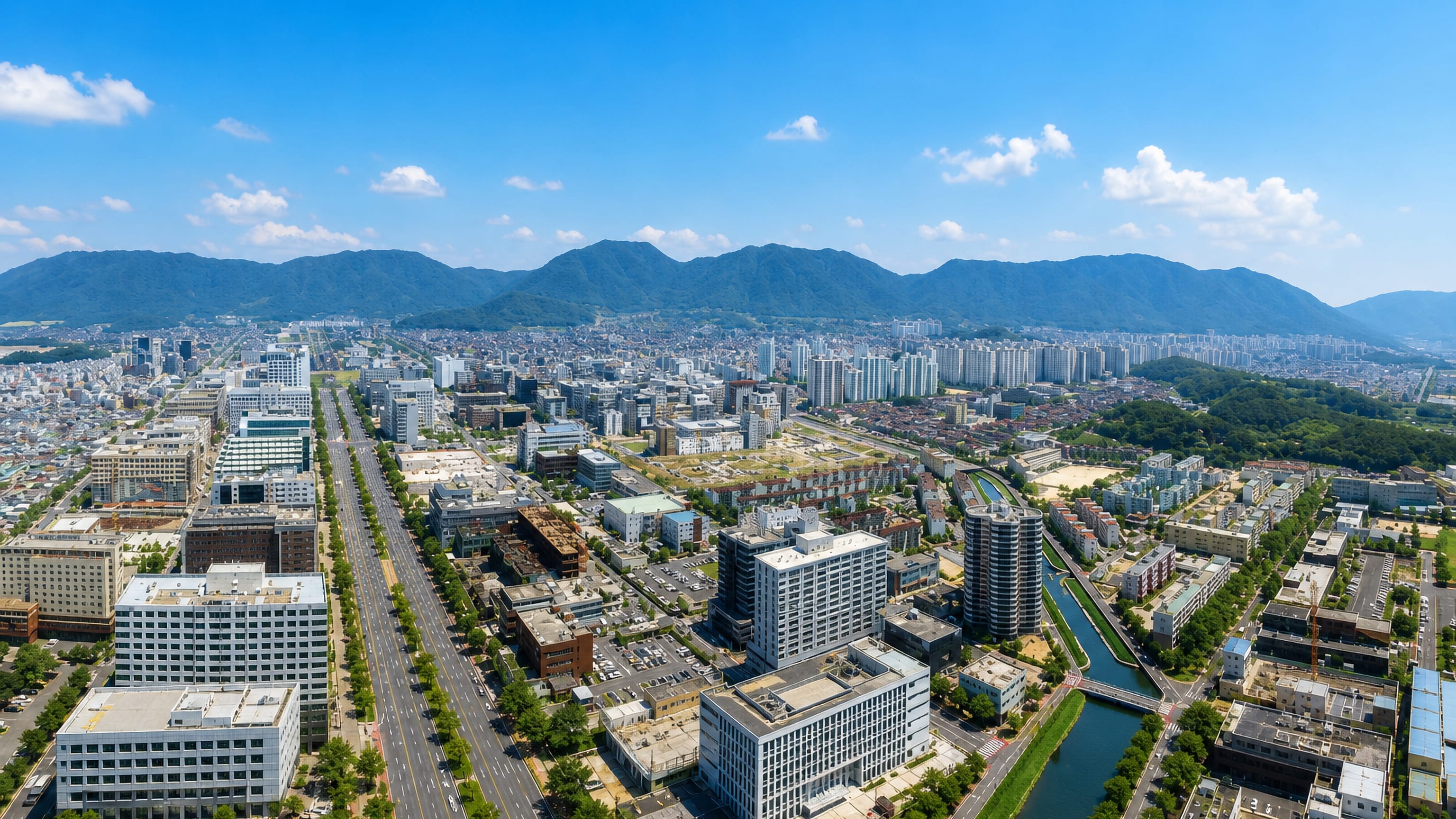 Changwon, South Korea, with its wide planned boulevard, low-rise blocks and mountain ridges on the horizon.