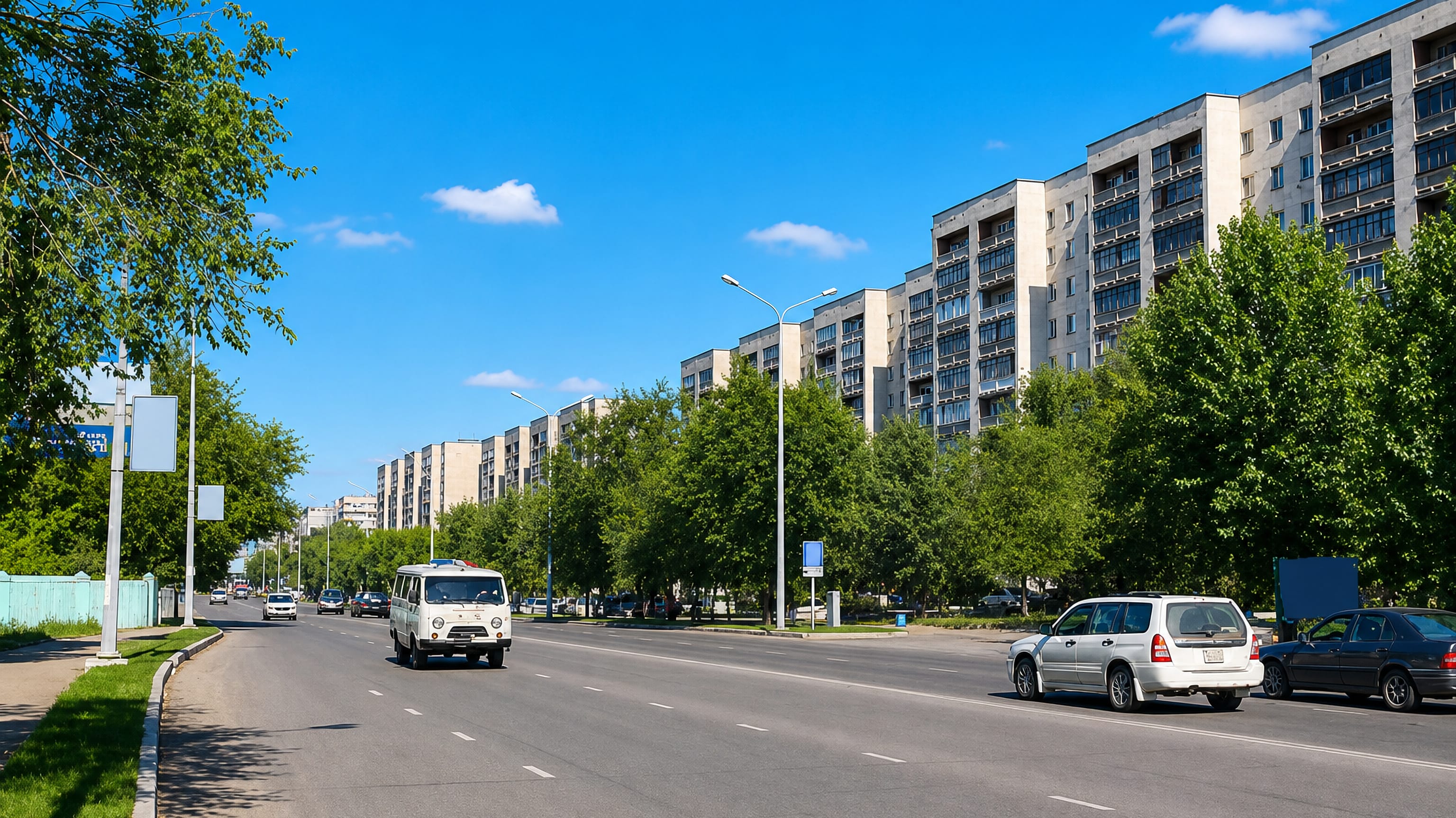 A wide tree-lined boulevard in Semey, Kazakhstan, flanked by Soviet-era apartment blocks under a clear sky.
