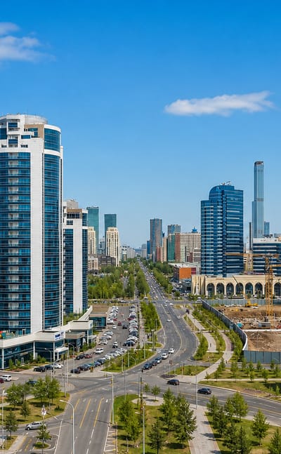 Astana skyline of modern high-rise towers along a wide boulevard in Kazakhstan's capital.
