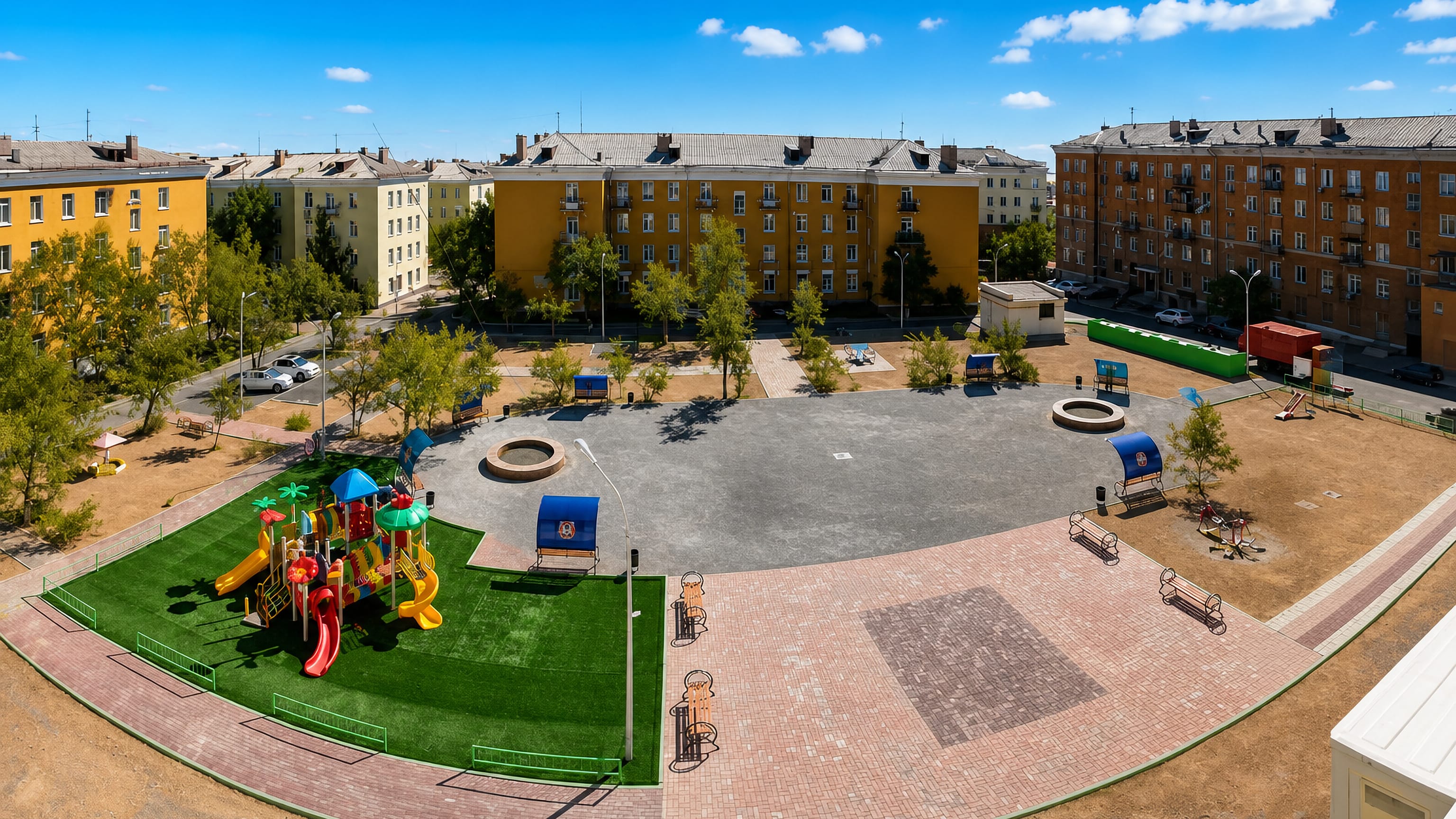 Soviet-era apartment blocks around a paved courtyard and playground in Balqash, Kazakhstan.