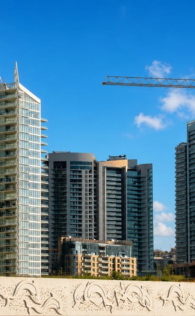 Cluster of modern glass high-rise towers behind a carved stone balustrade in Beirut Central District.