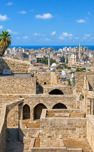 The stone Citadel of Raymond de Saint-Gilles overlooking Tripoli, Lebanon, with the city and Mediterranean beyond.