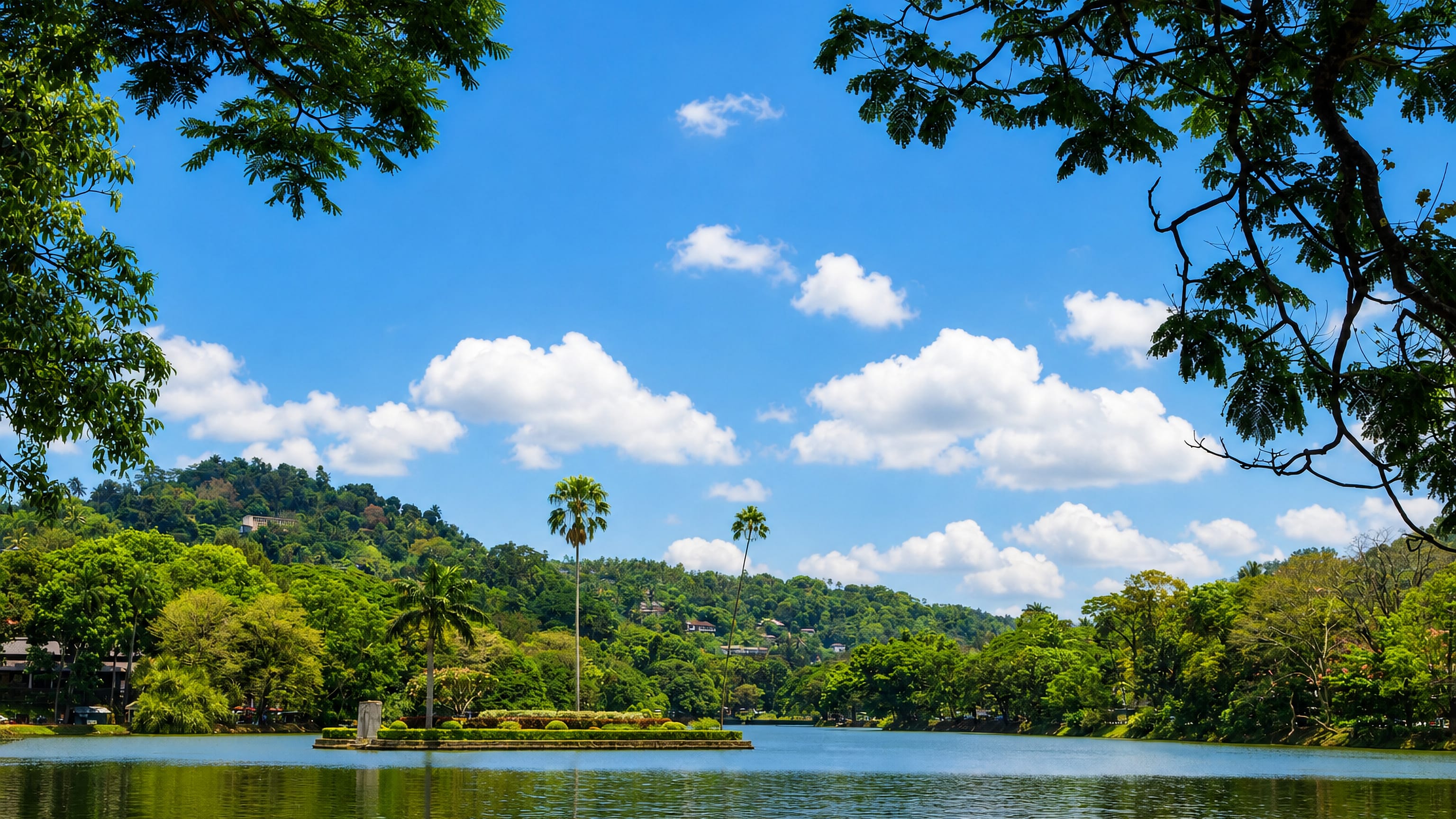 Kandy Lake in Sri Lanka's hill country, its small central island ringed by palms below forested ridges