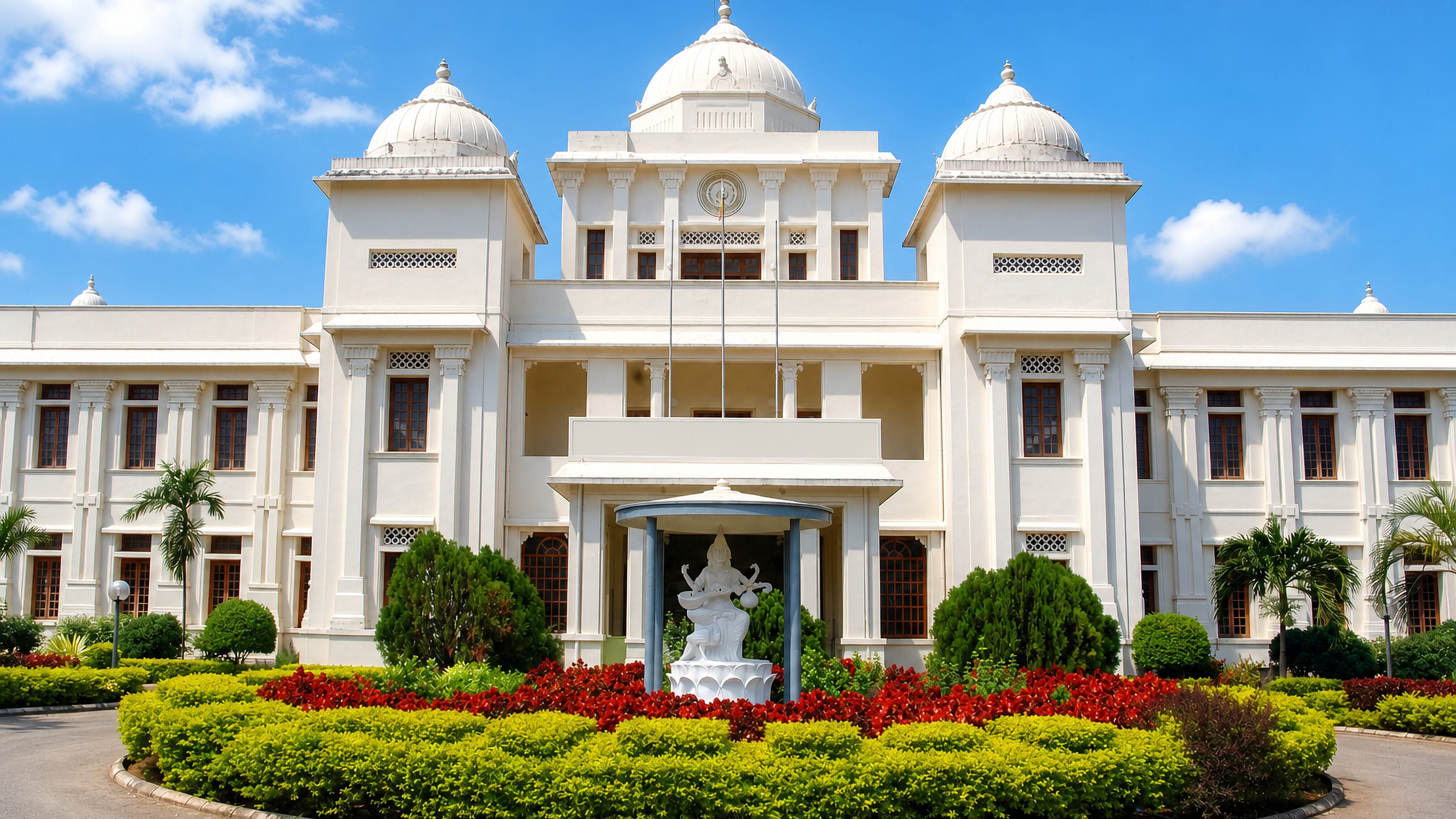 The white domed Jaffna Public Library and its Saraswathi statue above flower beds in Jaffna, Sri Lanka.