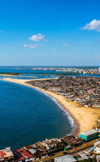 Aerial view of Monrovia's sandy West Point peninsula between the Atlantic Ocean and the Mesurado estuary.