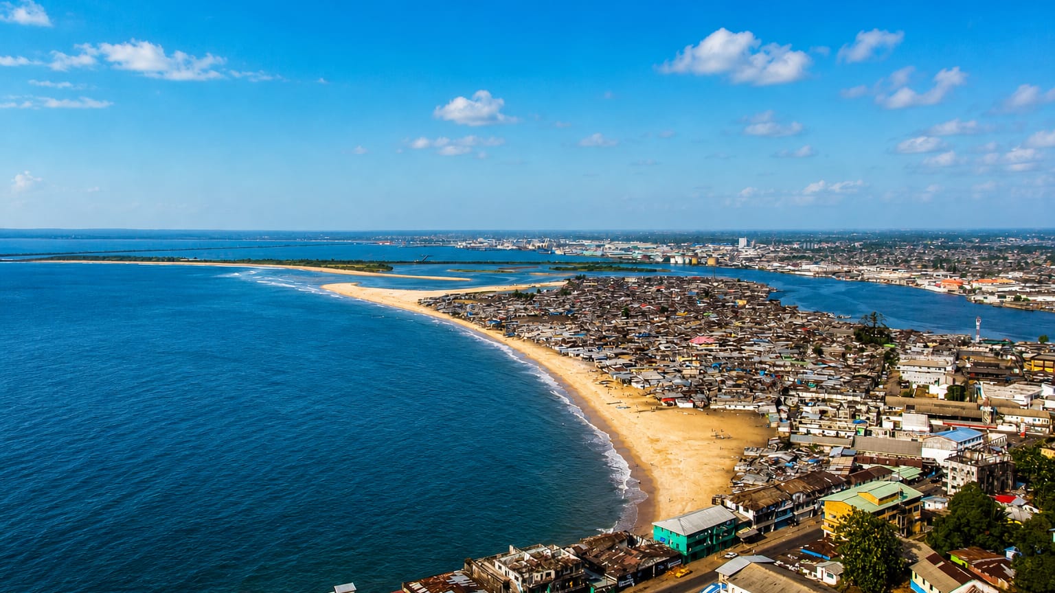 Aerial view of Monrovia's sandy West Point peninsula between the Atlantic Ocean and the Mesurado estuary.