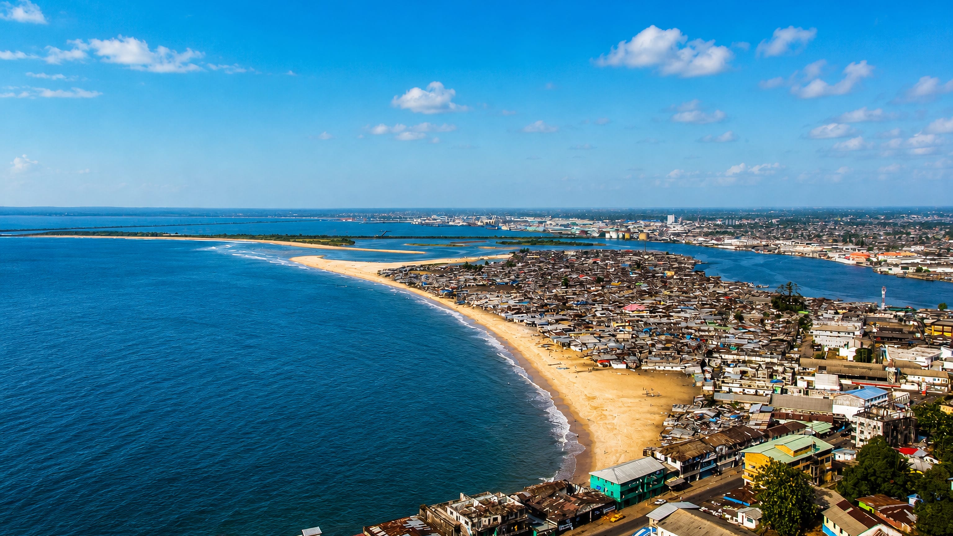 Aerial view of Monrovia's sandy West Point peninsula between the Atlantic Ocean and the Mesurado estuary.