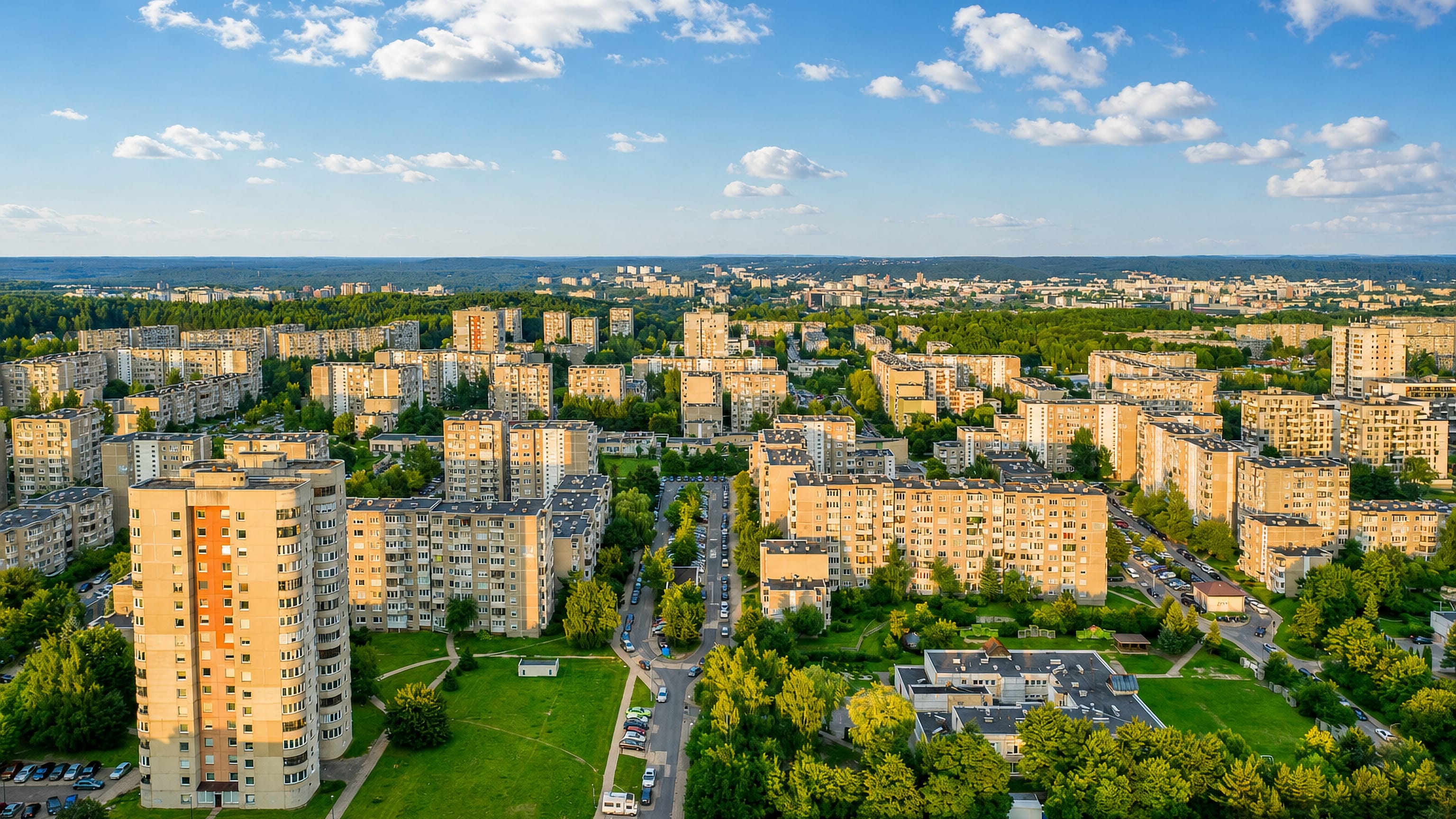 Aerial view of Soviet-era apartment blocks and green courtyards across Fabijoniskes in northern Vilnius.