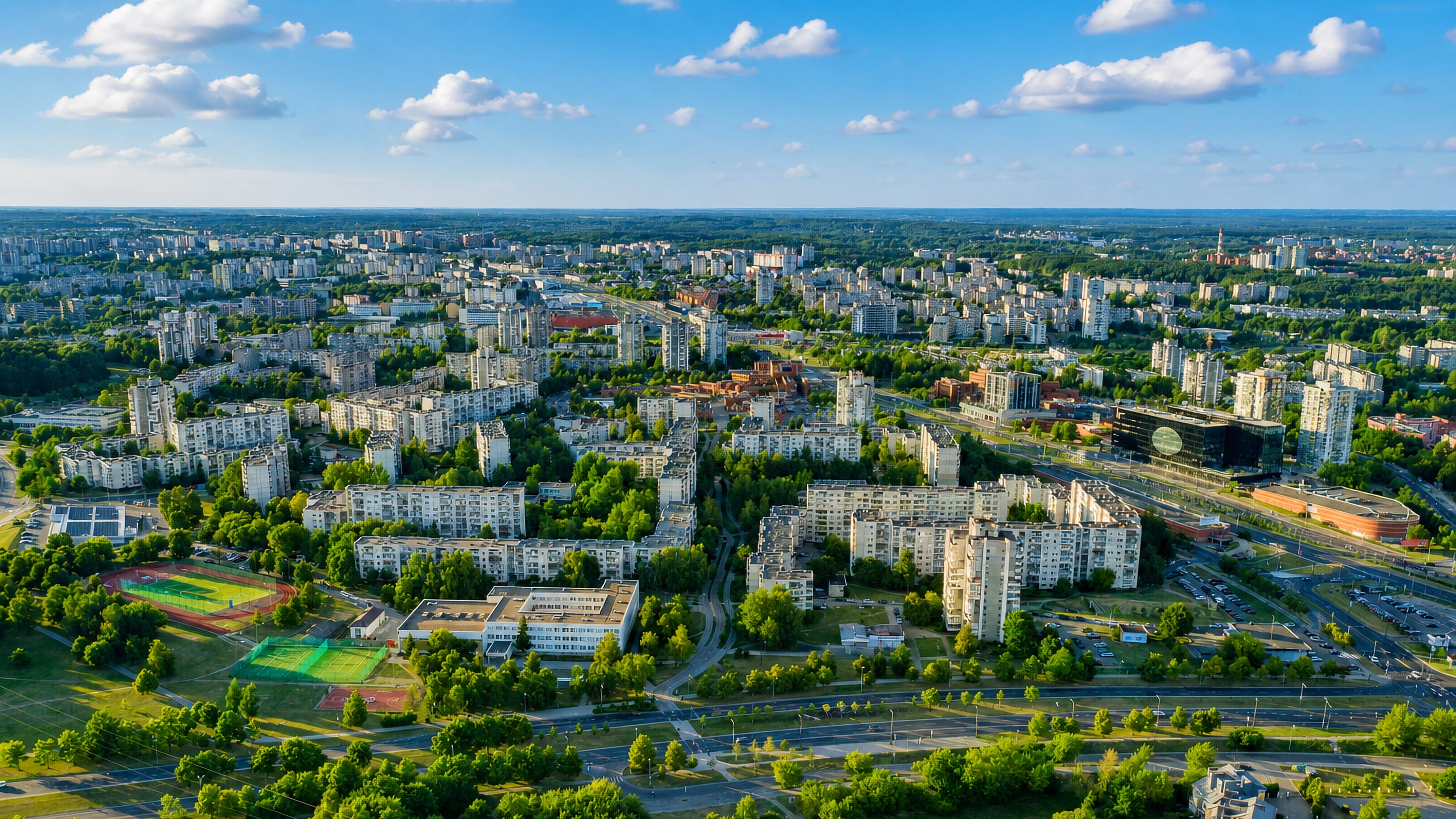 Aerial view over Šeškinė's Soviet-era apartment blocks, parks and sports grounds in Vilnius.