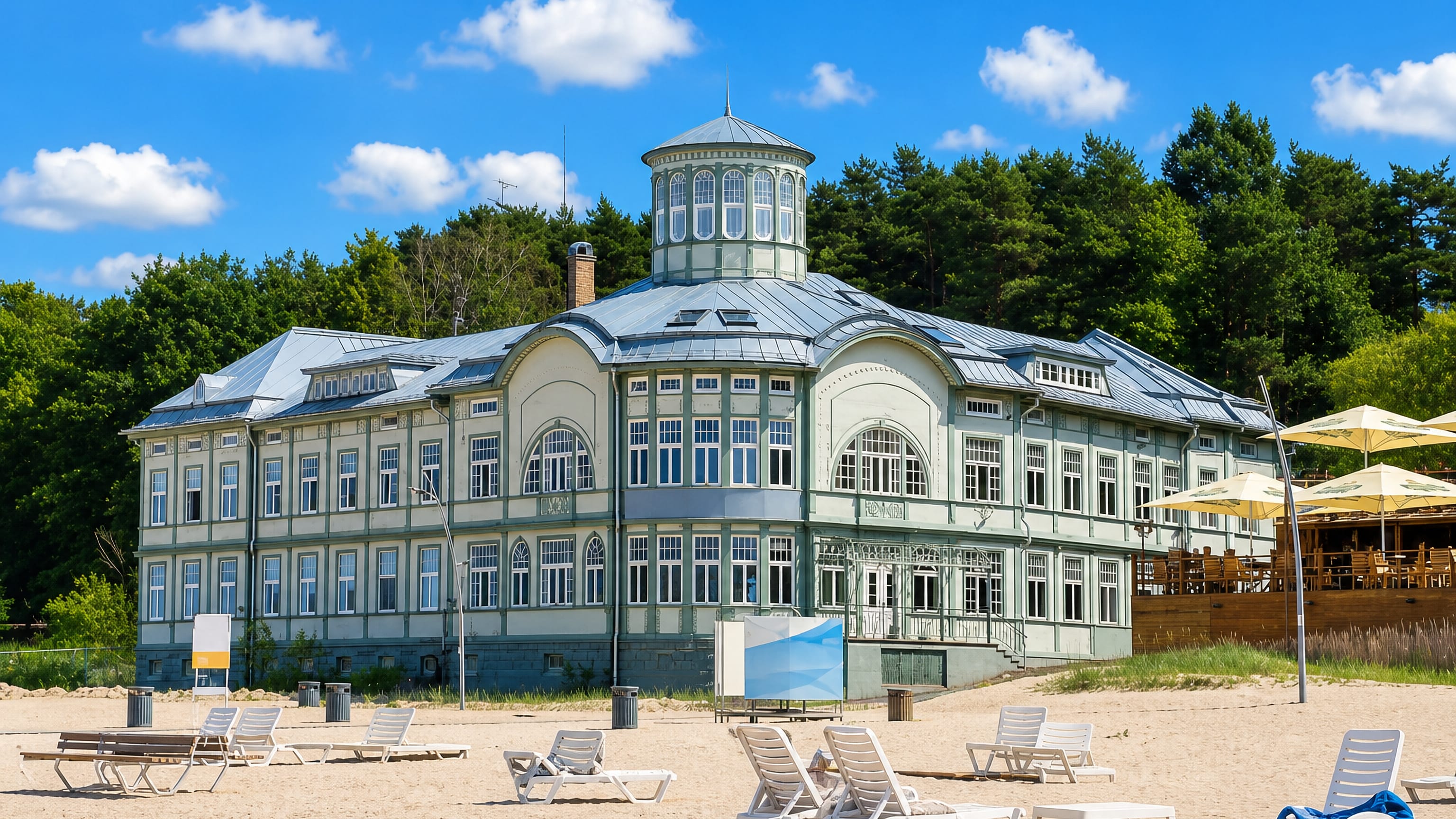 Historic wooden spa bathhouse and sun loungers on the sandy Baltic beach at Jūrmala, Latvia