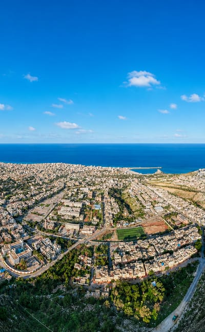 Aerial view of Derna set in a green valley between plateaus along the Libyan Mediterranean coast.