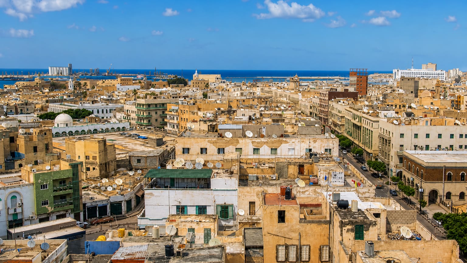 Rooftop panorama over Tripoli's old city and mosque minaret toward the Mediterranean port