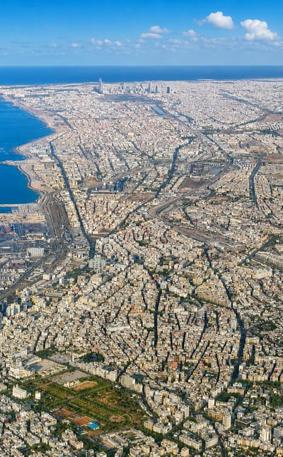 Aerial view of Casablanca's dense urban sprawl along the Atlantic coast with its port, Morocco.