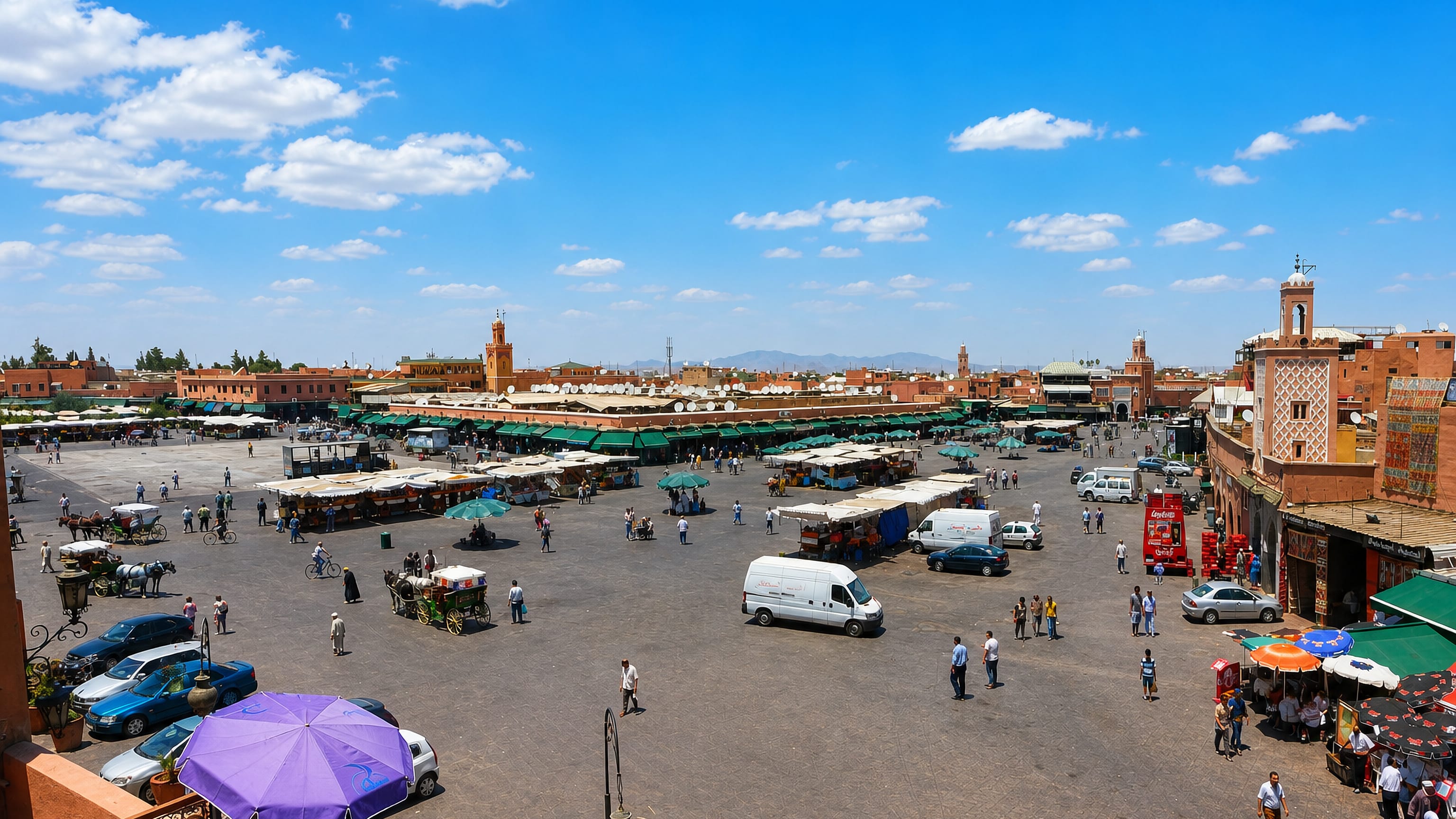 Marrakesh's Jemaa el-Fnaa square with market stalls, horse carriages, red medina walls and a minaret under a bright sky