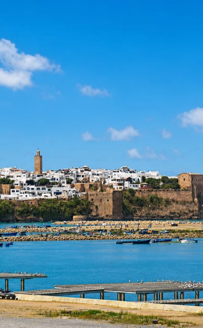 Rabat's Kasbah of the Udayas and whitewashed medina above the Bou Regreg estuary lined with blue fishing boats