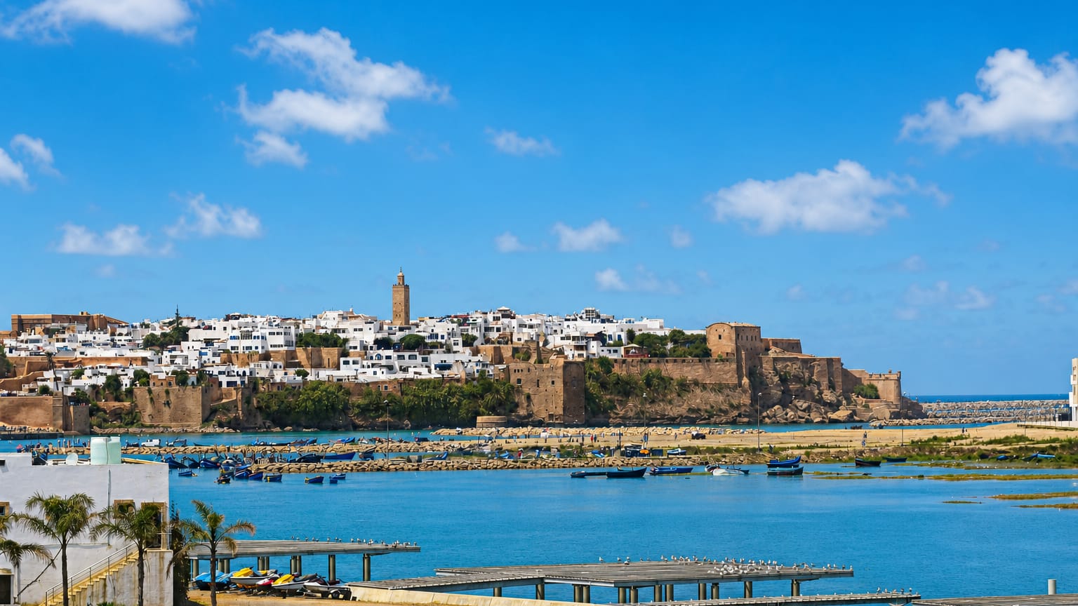 Rabat's Kasbah of the Udayas and whitewashed medina above the Bou Regreg estuary lined with blue fishing boats