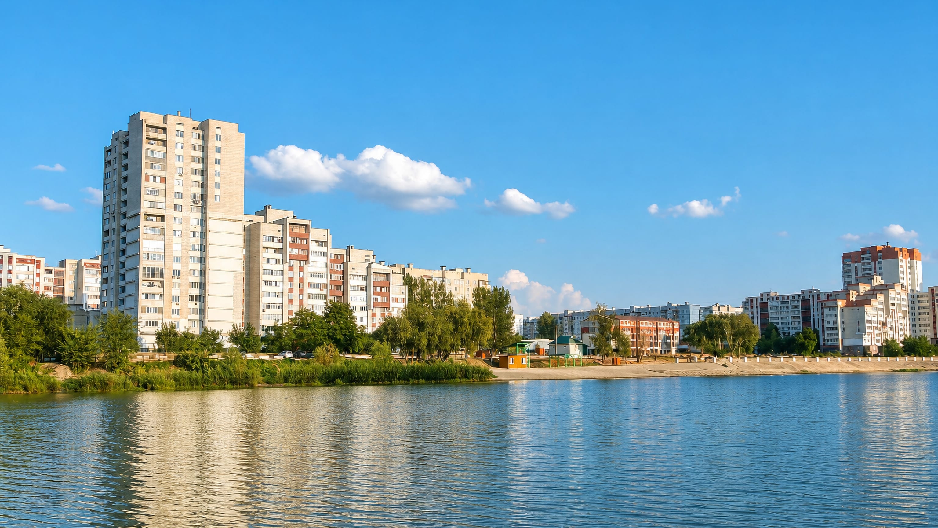 Apartment blocks and a sandy riverside beach along the Dniester at Rîbniţa, Moldova.