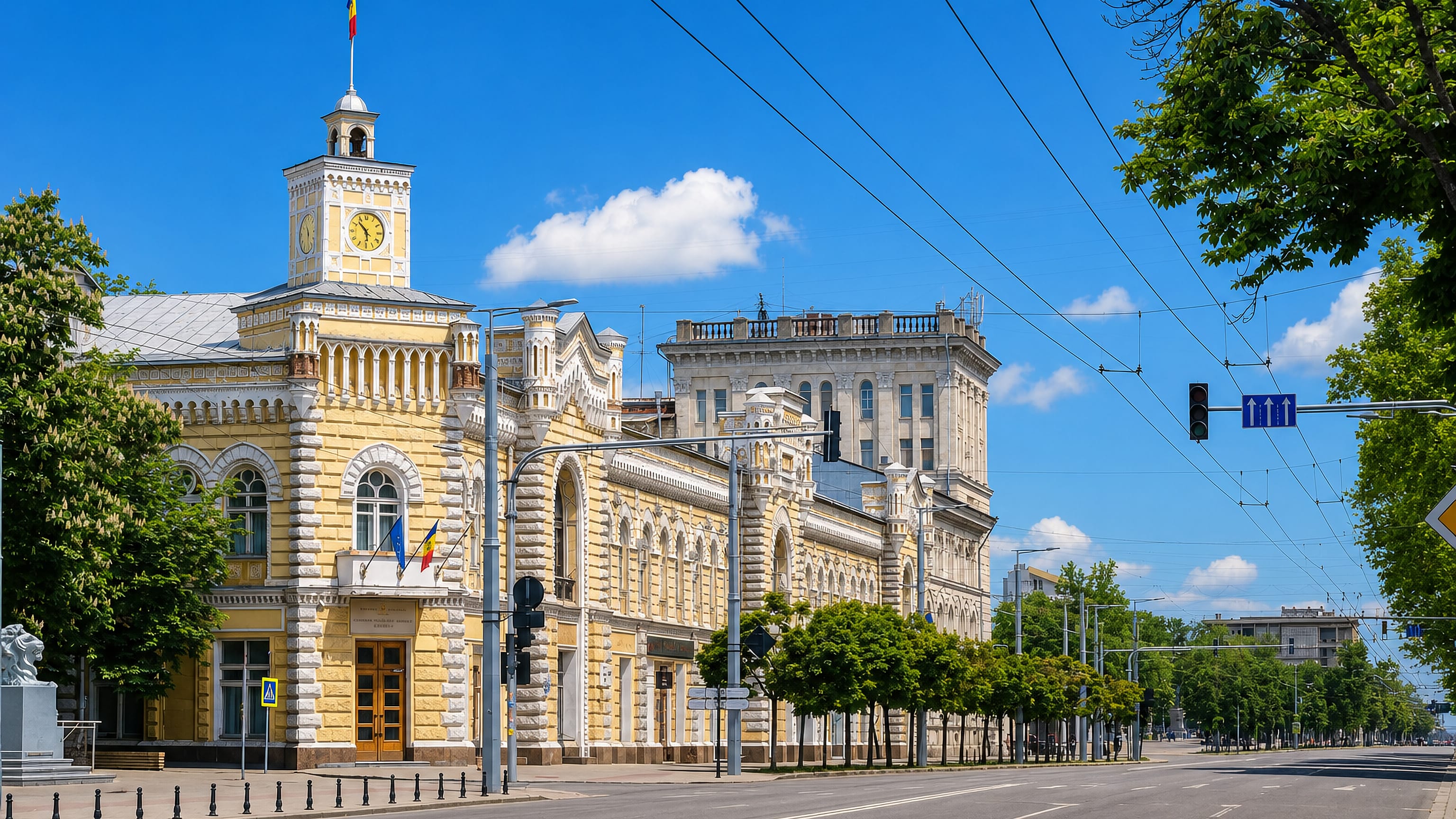 Chisinau City Hall's yellow facade and clock tower on the main boulevard in the Centru sector.