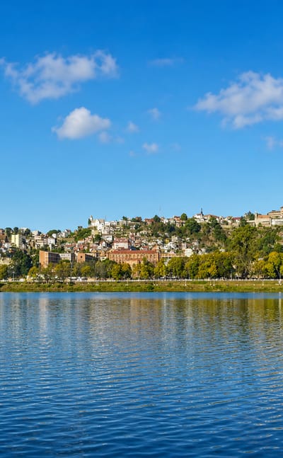 Lake Anosy in Antananarivo with its island war memorial and the hillside city topped by the royal palace