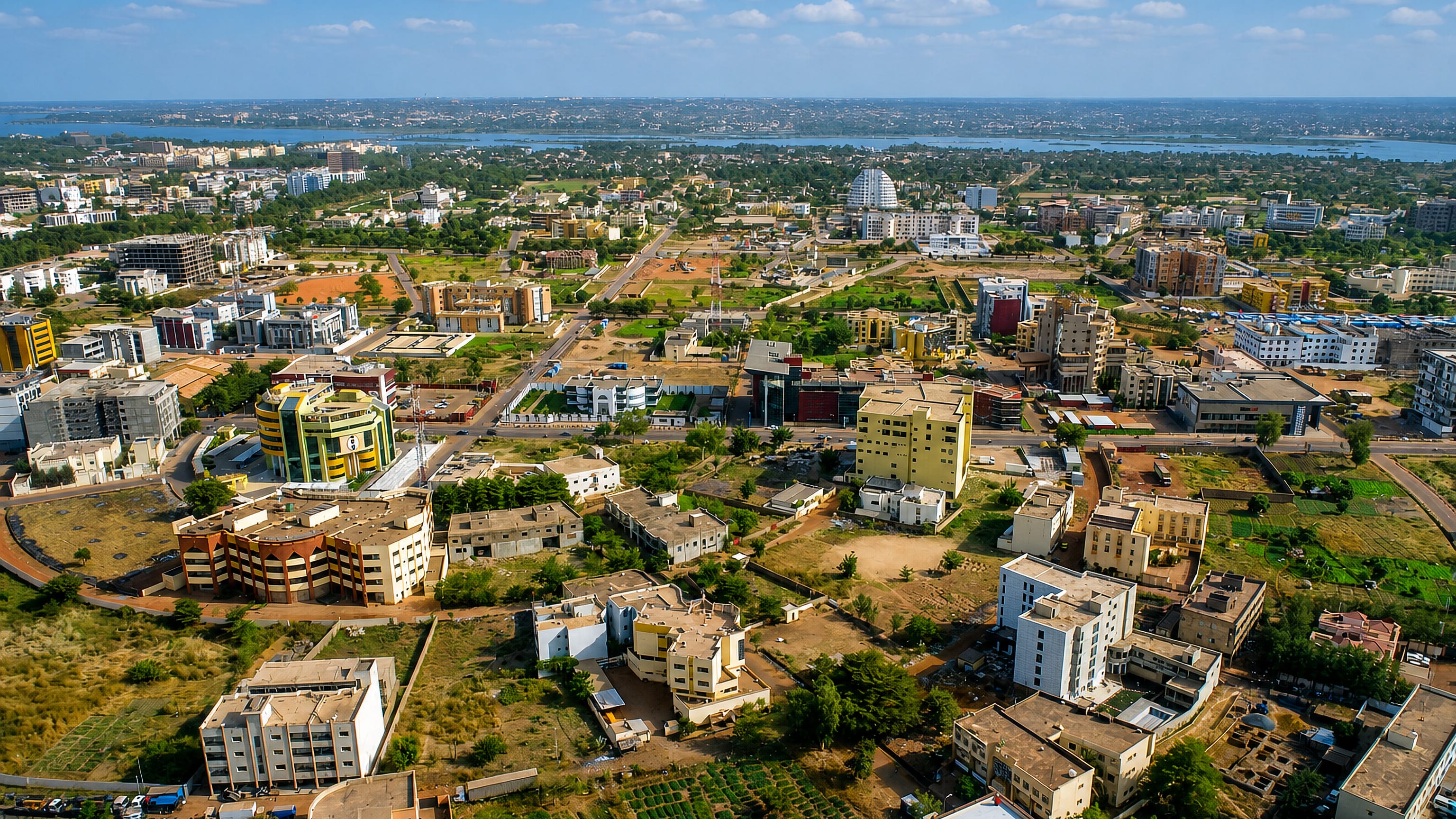 Aerial view across Bamako's low-rise ACI 2000 quarter toward the Niger River and its sandbanks