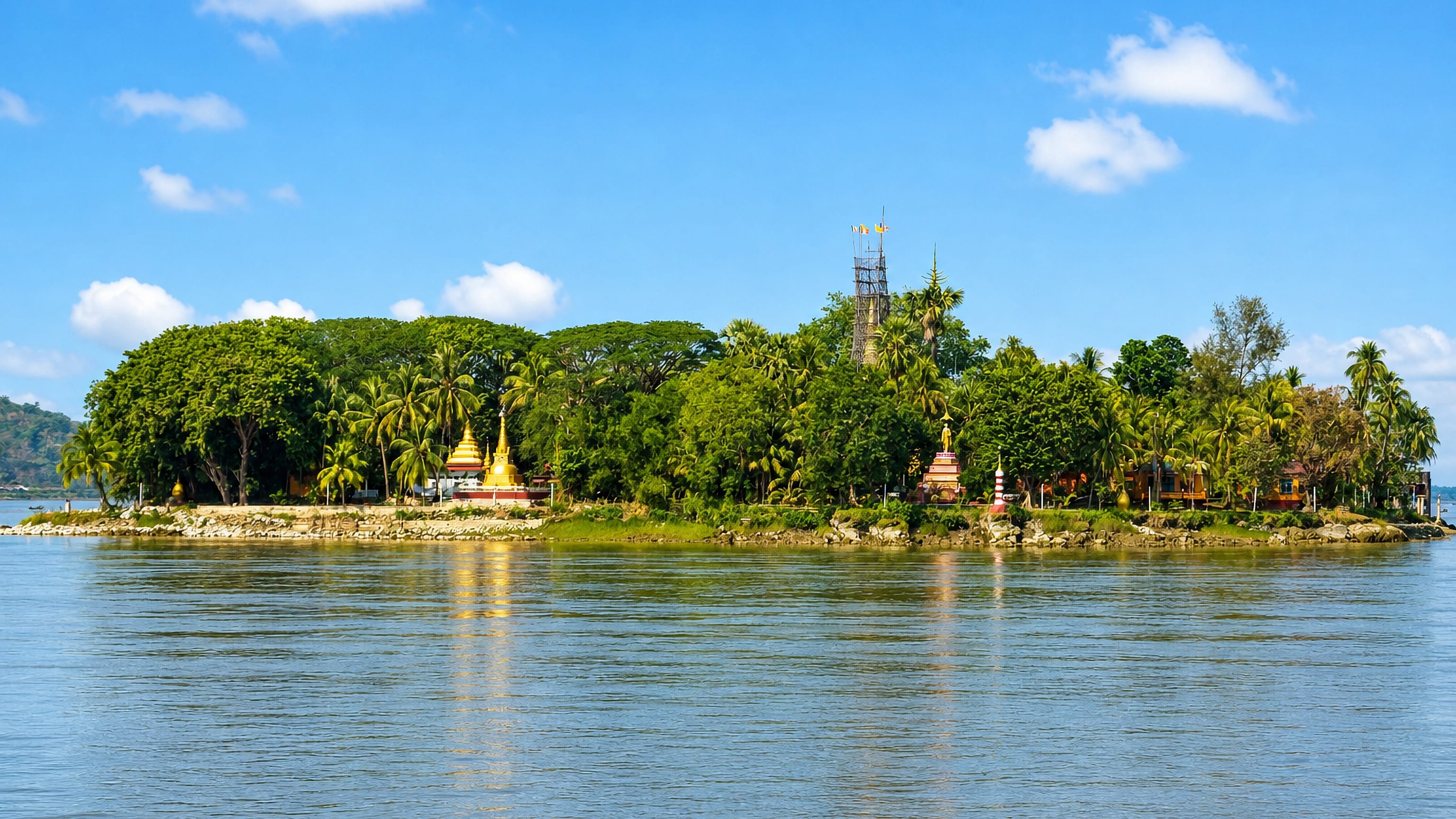 A palm-covered river island topped by golden stupas on the Thanlwin River at Mawlamyine, Myanmar.