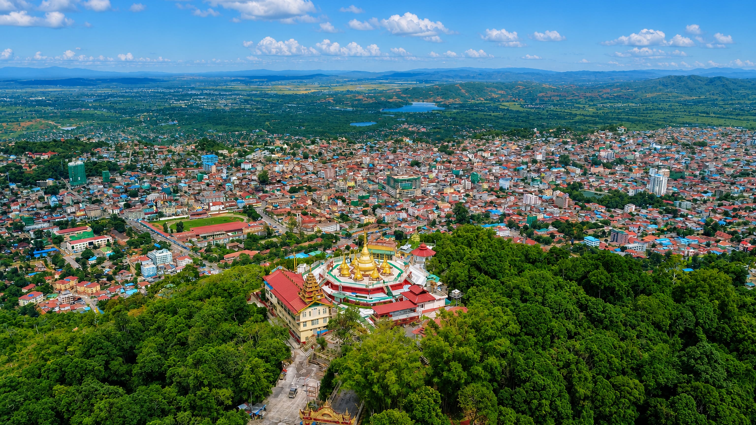 Taunggyi spread across its valley below a gilded hilltop pagoda, with the Shan hills on the horizon