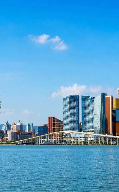 Macau skyline with the lotus-shaped Grand Lisboa tower and Sai Van Bridge across the water