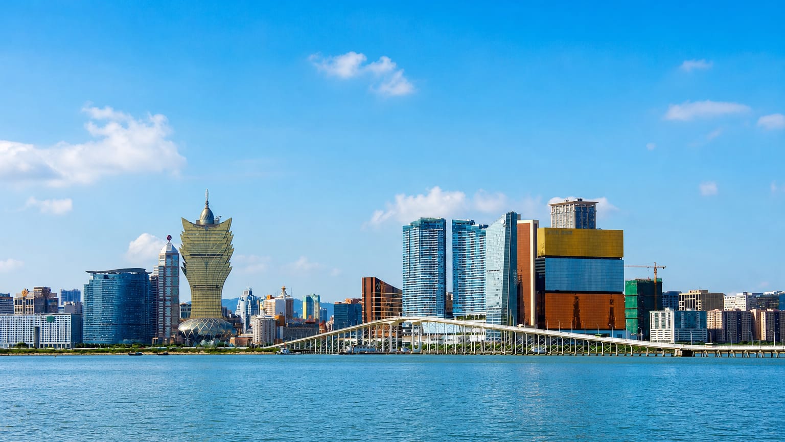 Macau skyline with the lotus-shaped Grand Lisboa tower and Sai Van Bridge across the water