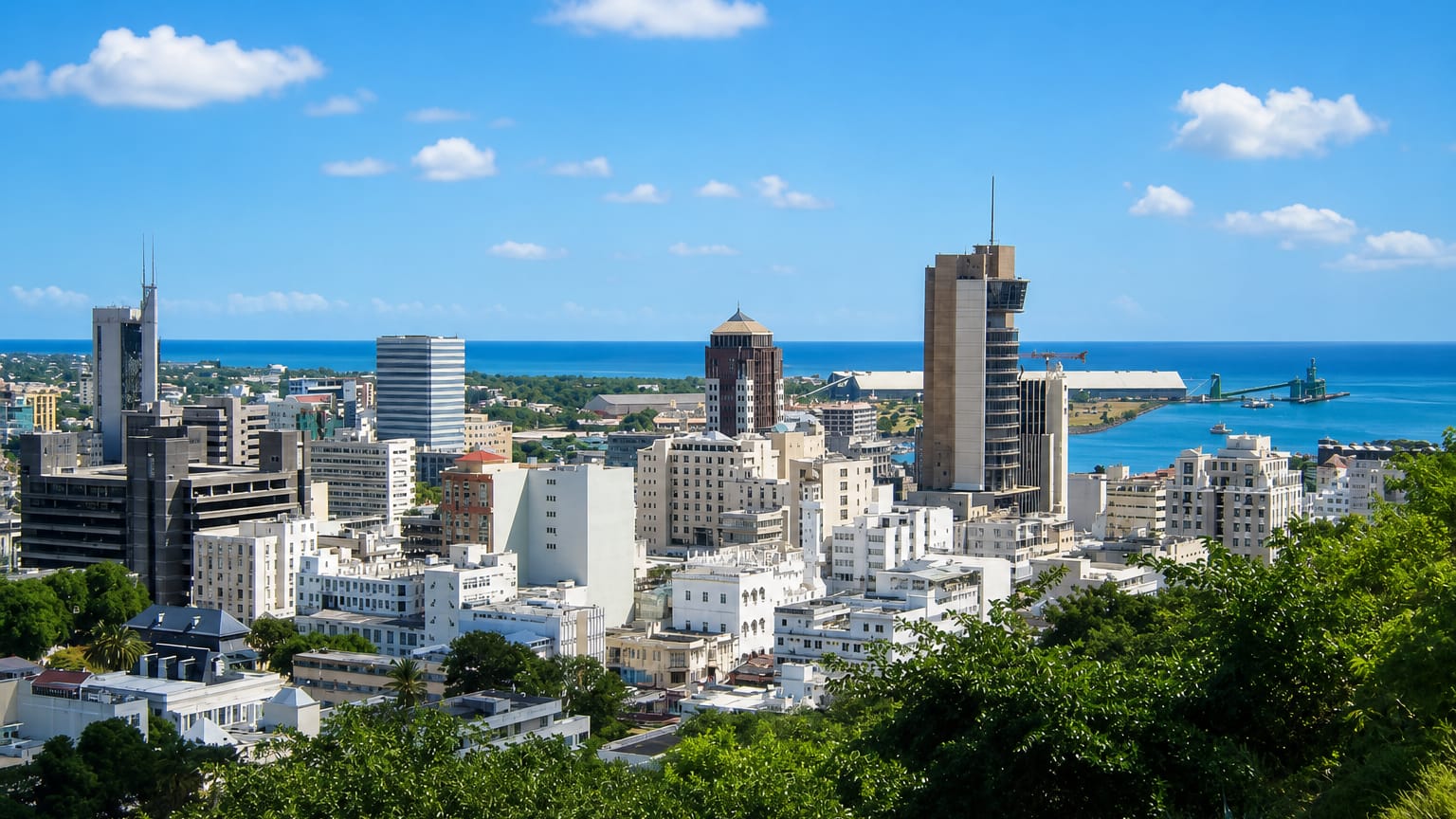 Port Louis skyline of towers and its Indian Ocean harbour seen from the green hills above the Mauritian capital