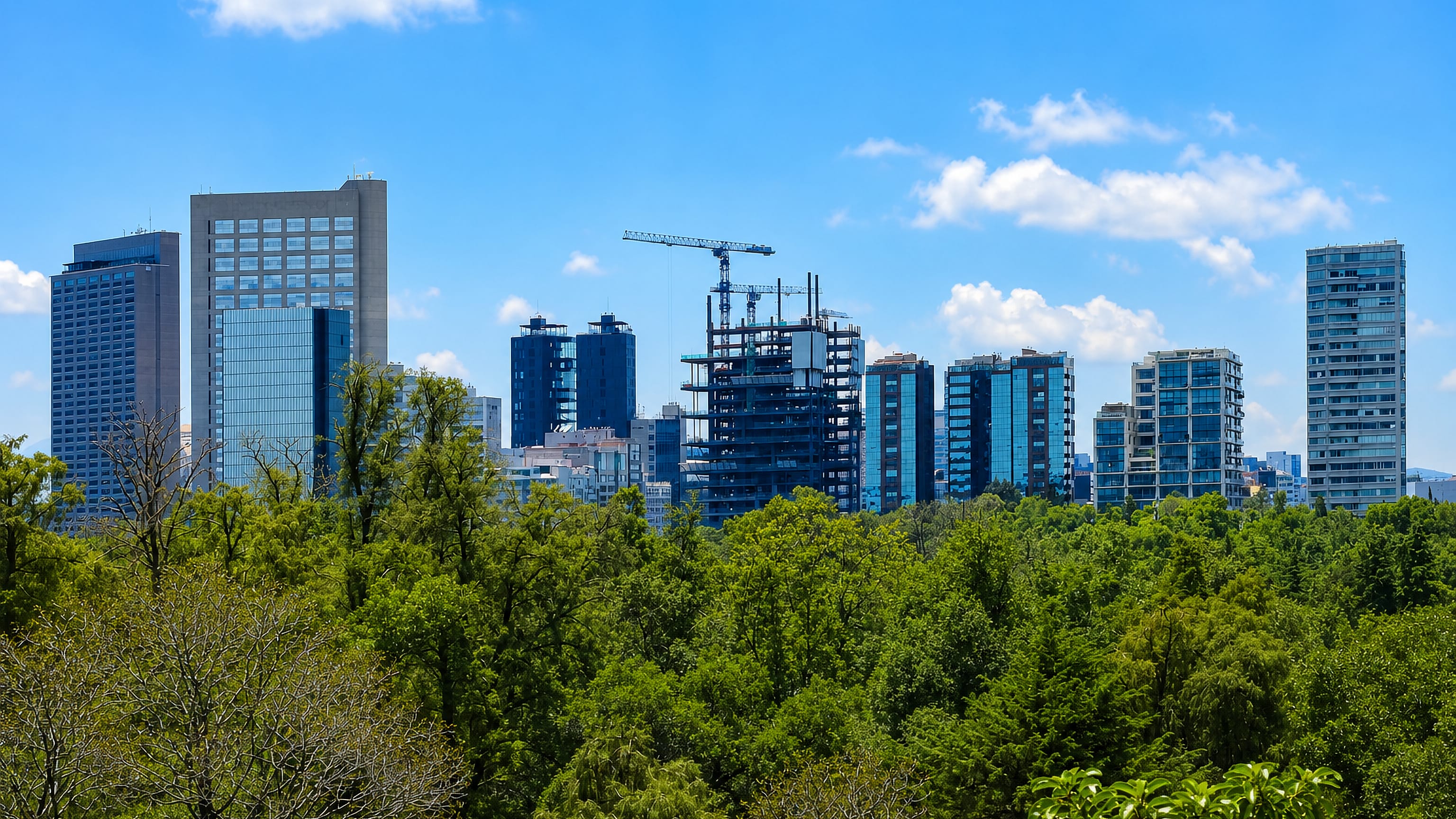 Modern high-rise towers of Miguel Hidalgo, Mexico City, rising above the dense green canopy of Chapultepec parkland