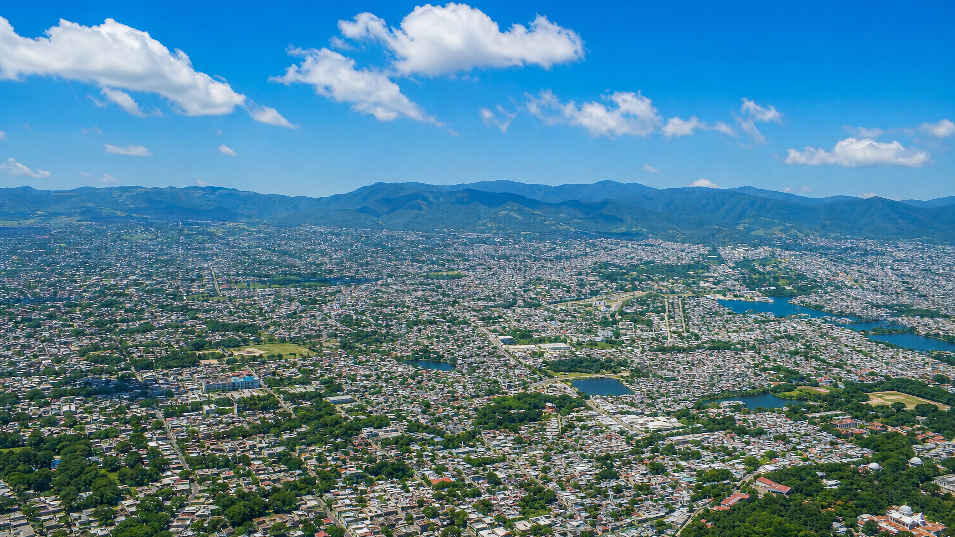 Aerial view of Tuxtla Gutierrez spread across its Chiapas valley below forested mountain ridges.