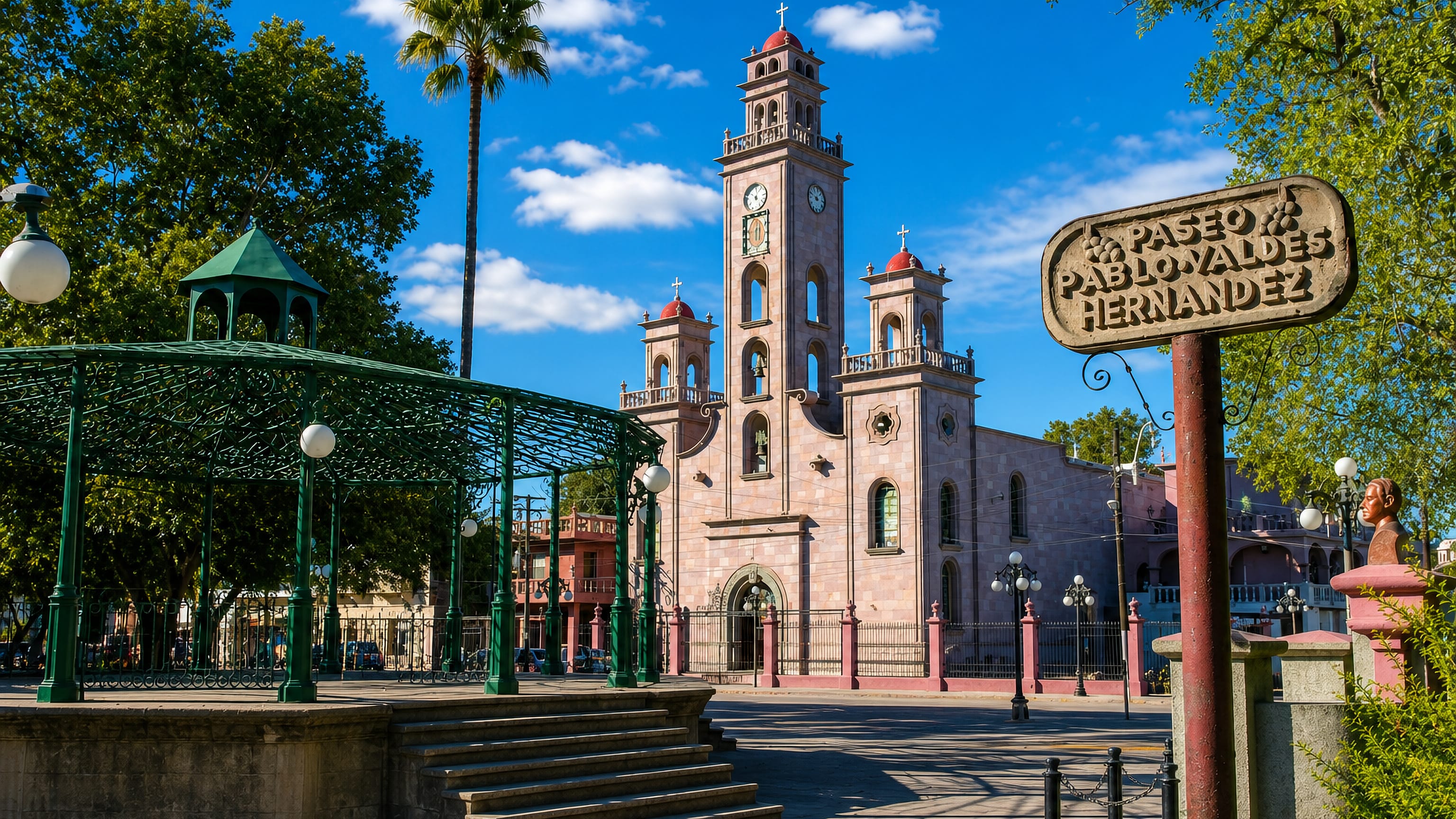 Piedras Negras' main plaza with its green wrought-iron bandstand and the pink stone church clock tower.