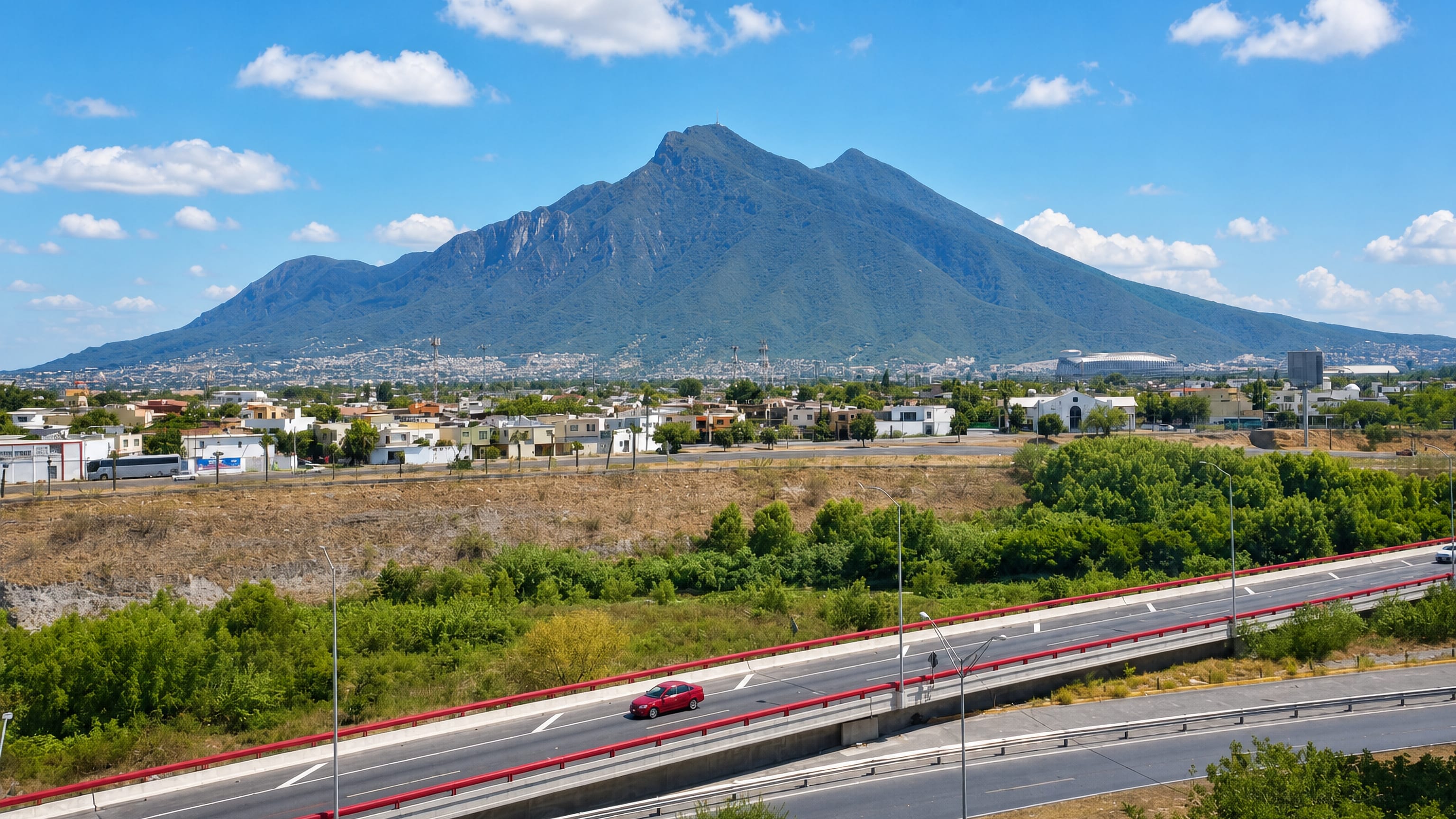 Cerro de la Silla towering over Guadalupe, Nuevo Leon, with the stadium and a divided highway below