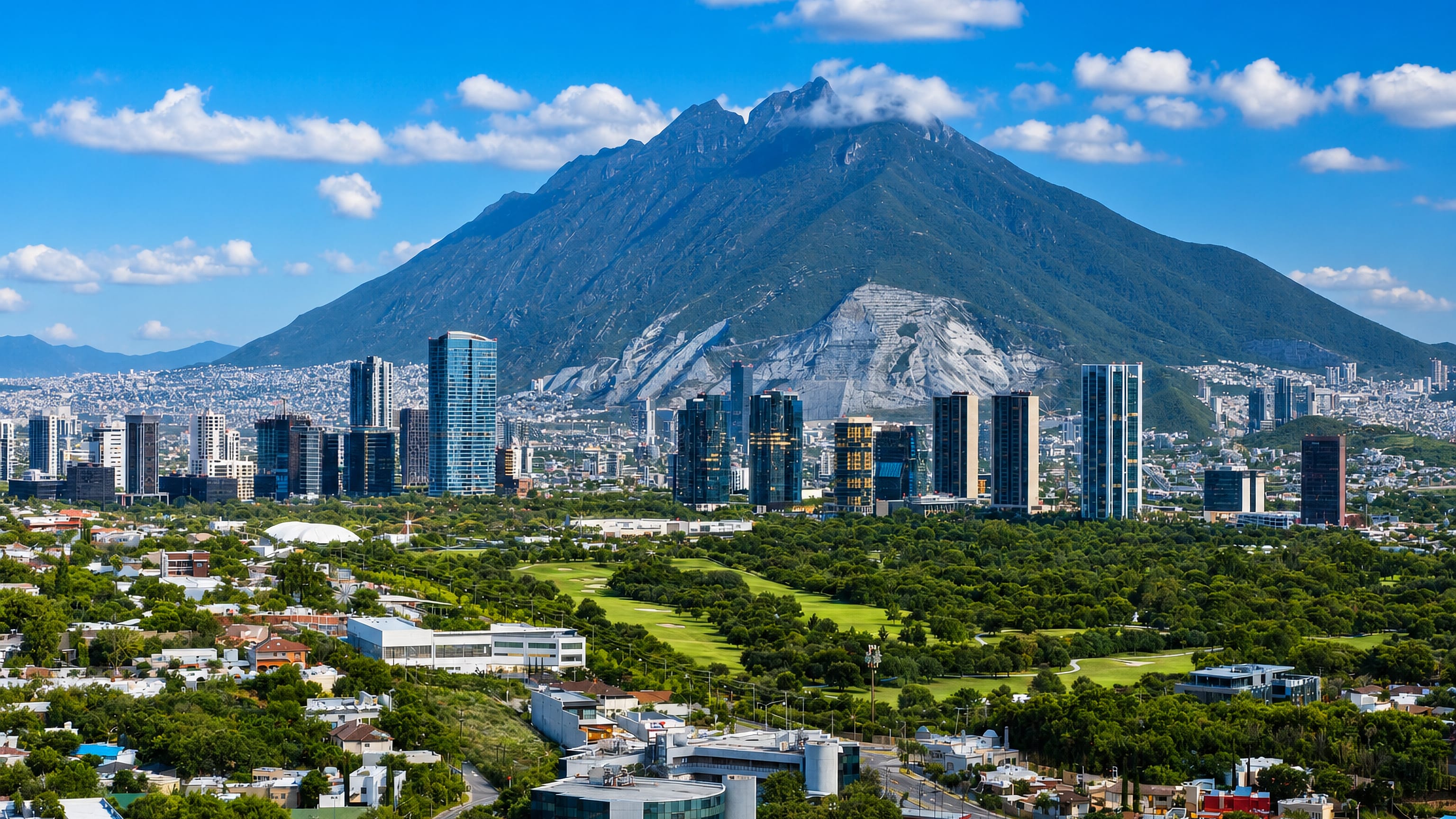 San Pedro Garza García's glass towers and golf greens below the saddle-shaped Cerro de la Silla, Monterrey.