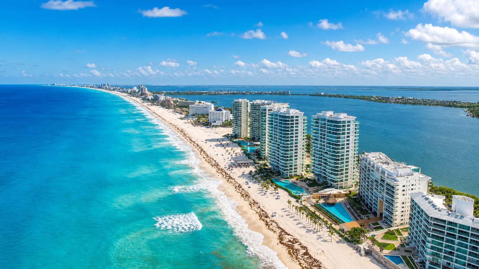 Cancún's Hotel Zone barrier island with beachfront resorts between the turquoise Caribbean and the lagoon