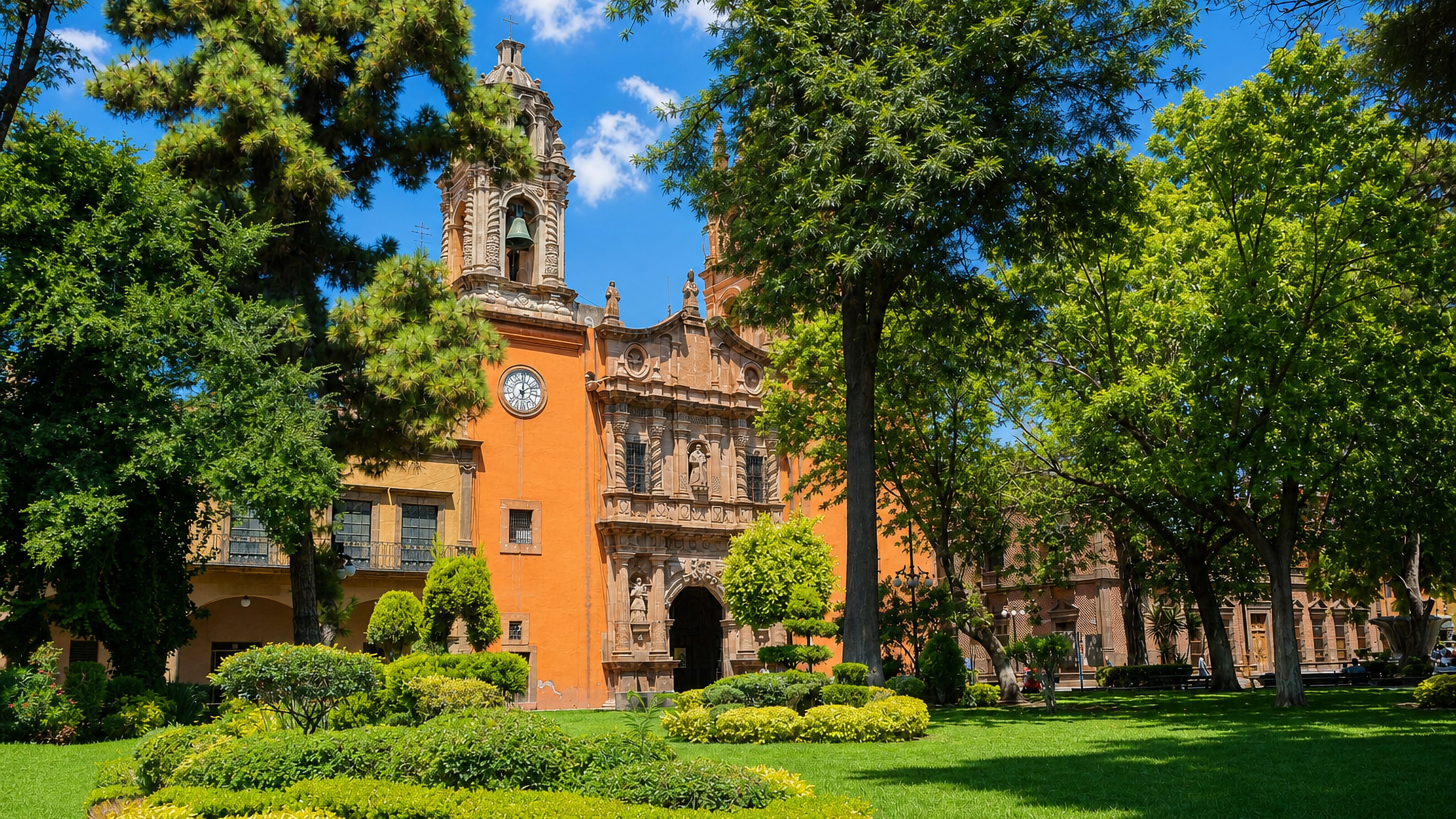 Ornate baroque church facade and shaded plaza gardens in the historic centre of San Luis Potosí, Mexico