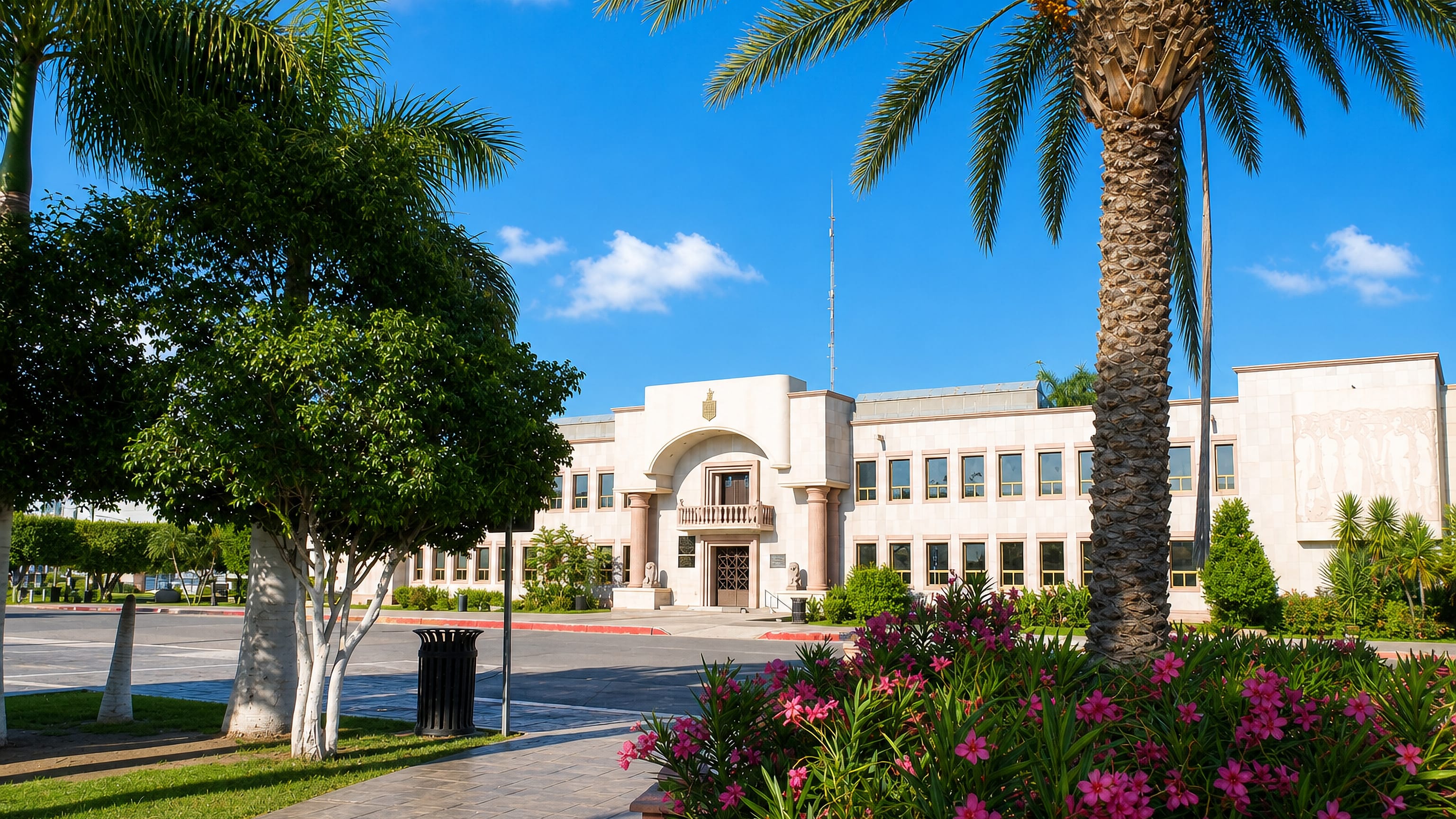 Modernist civic building framed by palms and oleander in Ciudad Obregón, Sonora, Mexico