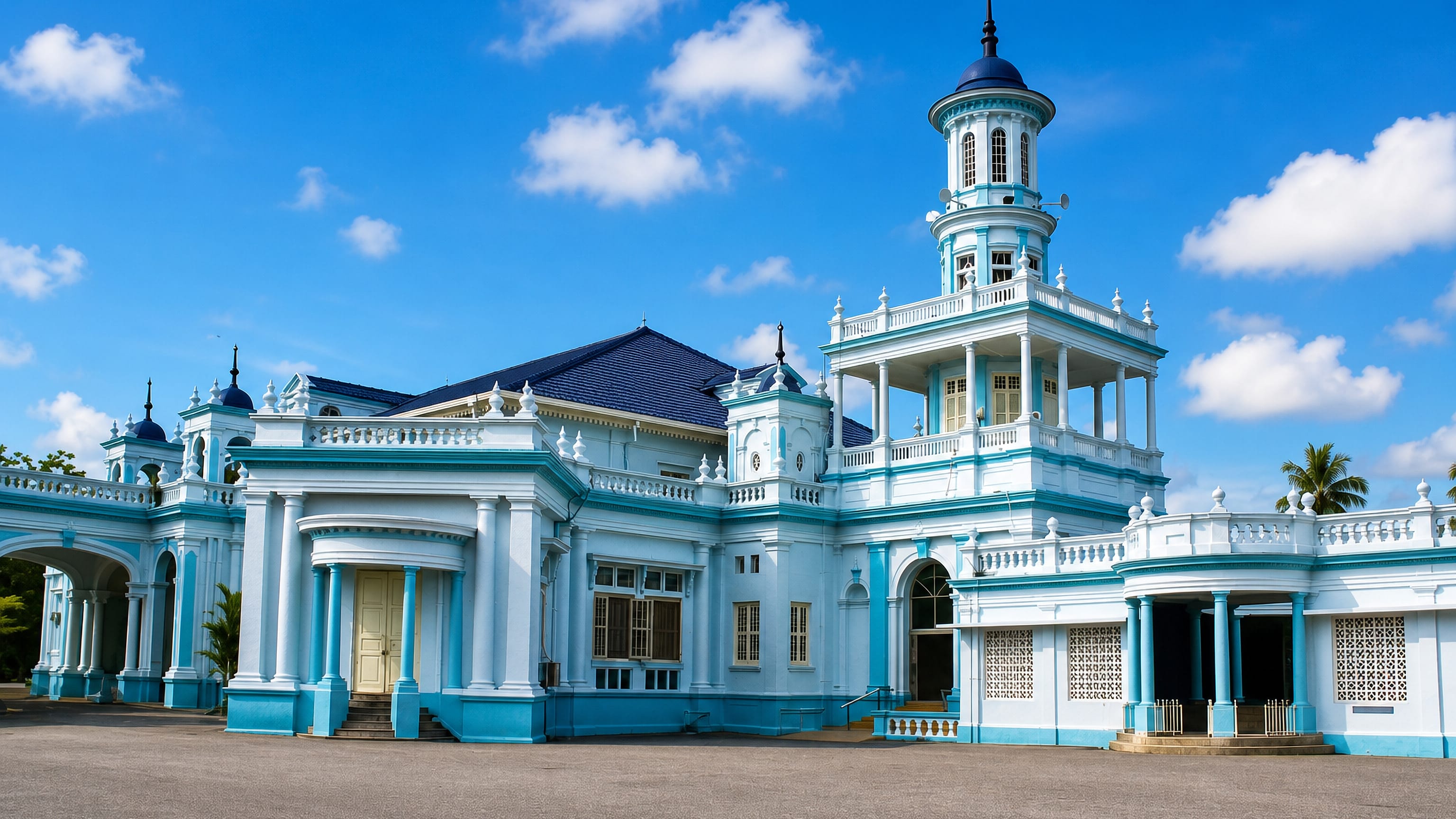 The blue-and-white Sultan Ibrahim Jamek Mosque and its domed tower in Muar, Malaysia.