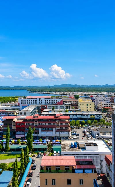 Colourful shophouses and market canopies along the bay at Lahad Datu on Sabah's east coast.