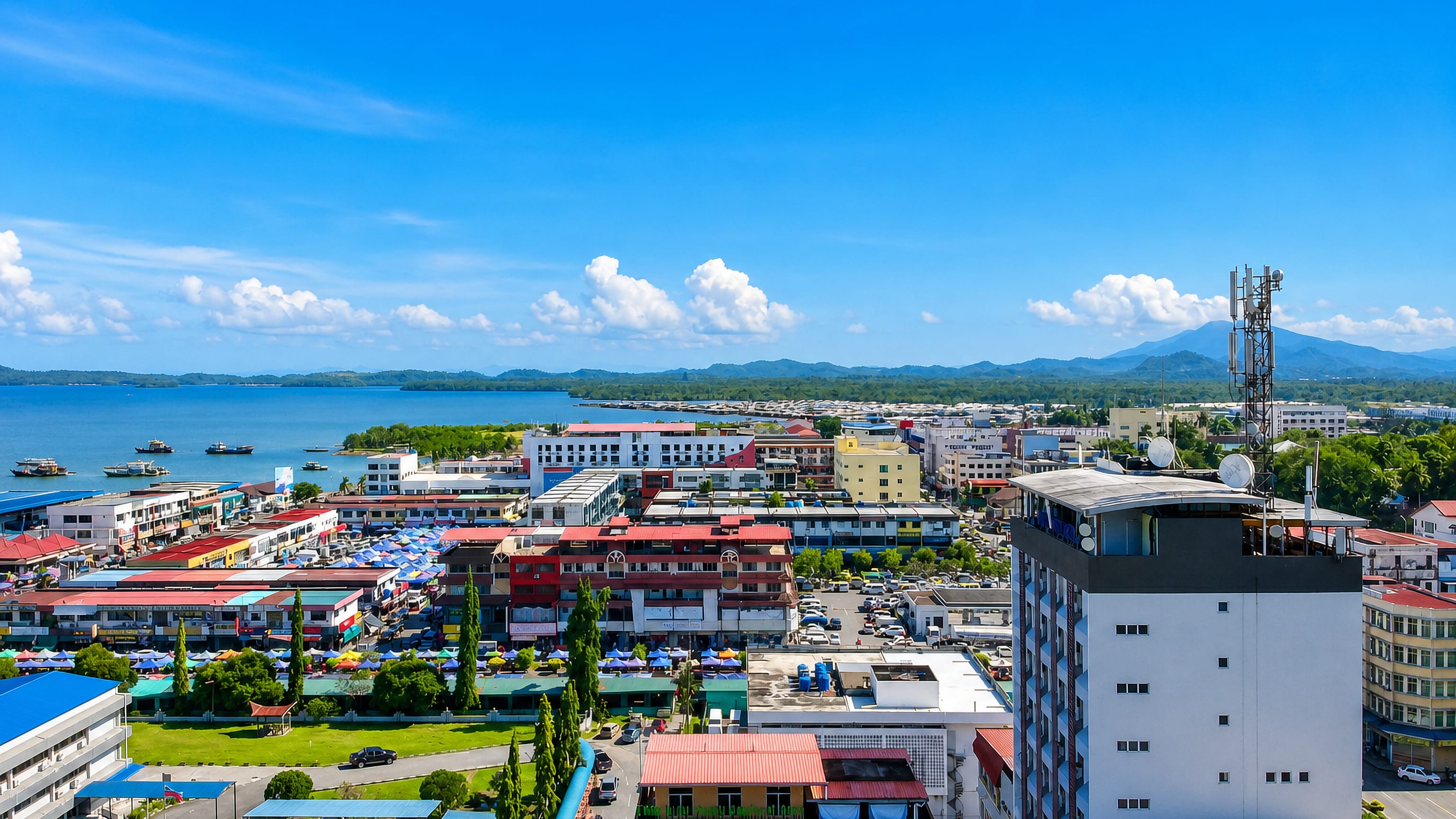 Colourful shophouses and market canopies along the bay at Lahad Datu on Sabah's east coast.