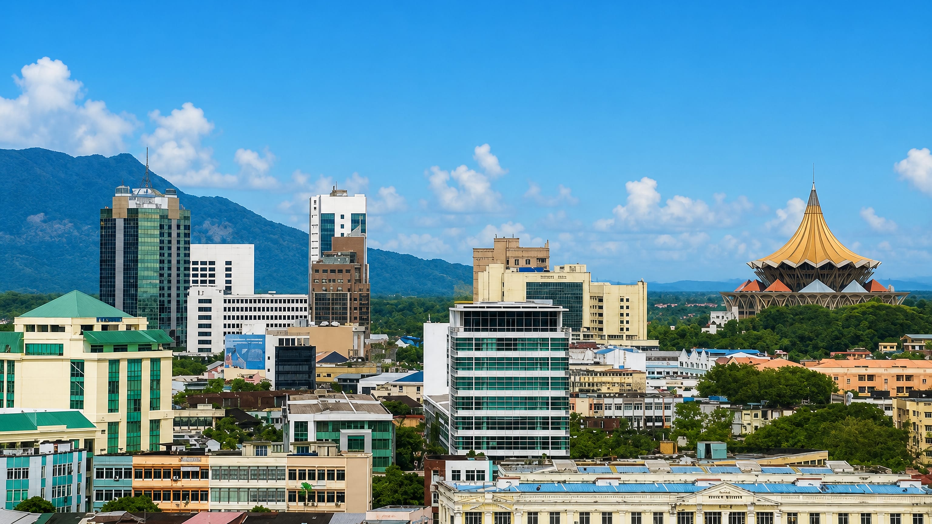 Kuching skyline in Sarawak, with the golden umbrella roof of the State Legislative Assembly and hills beyond