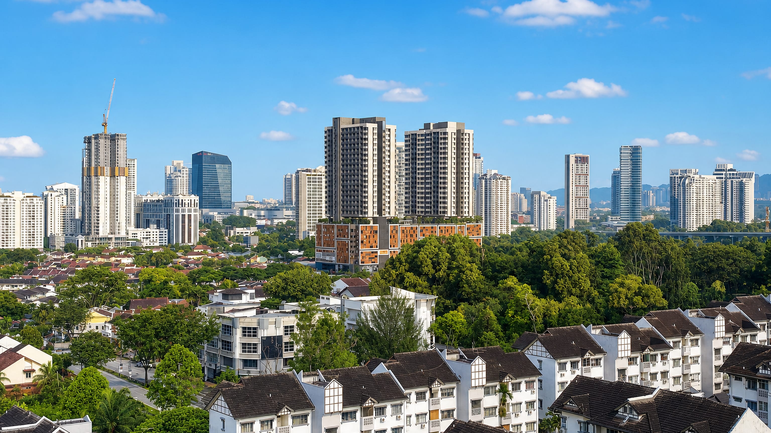 Petaling Jaya, Selangor, with high-rise condominiums rising above leafy terraced housing and treetops.