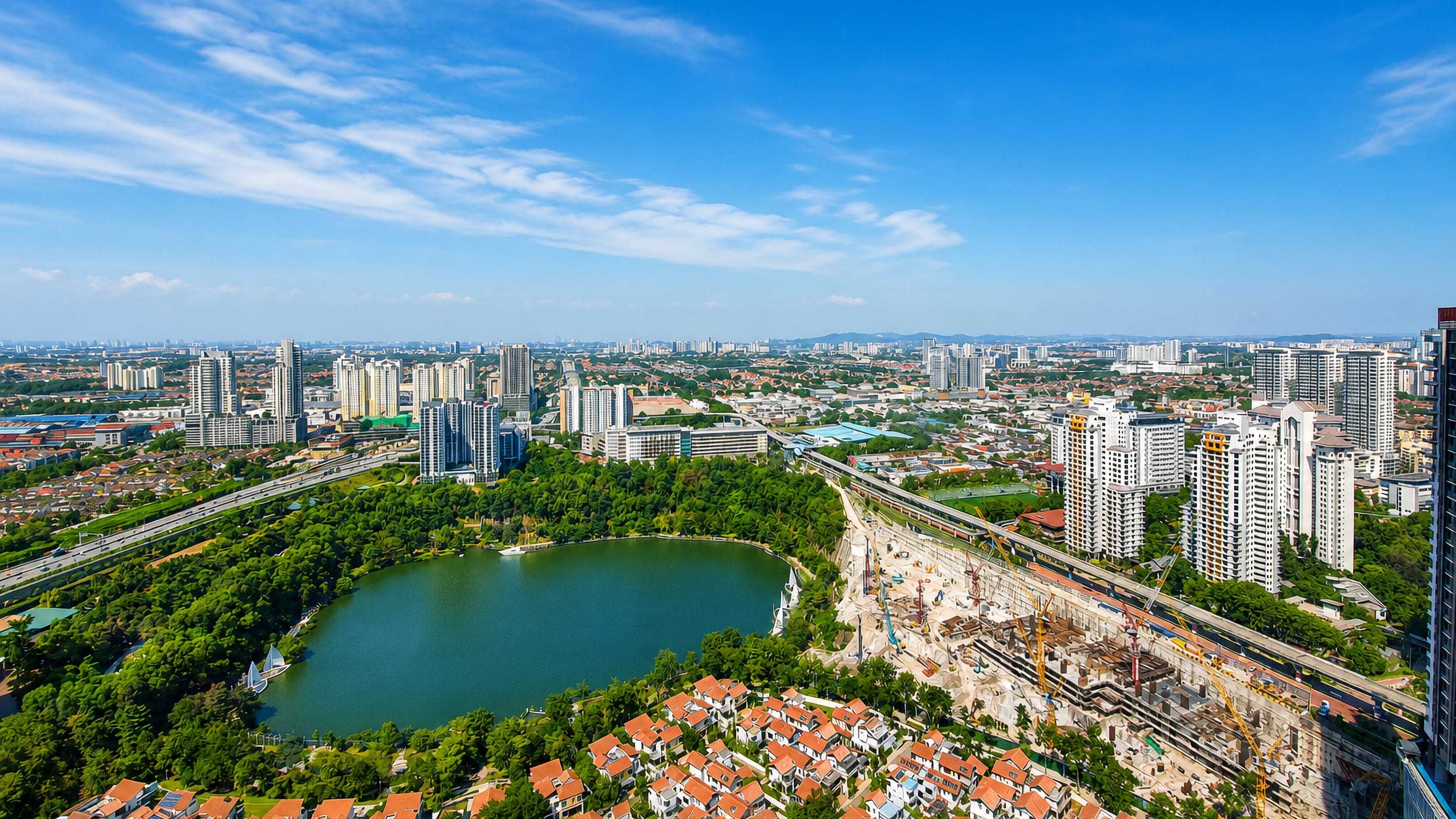 Aerial view of Bandar Sunway, Petaling Jaya, with its lake park, high-rise condominiums and transit line.