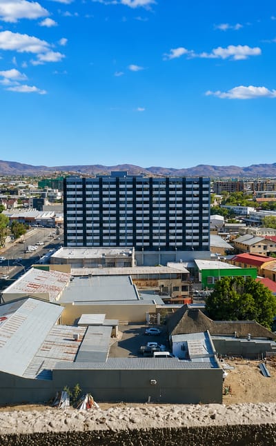 Windhoek's low-rise downtown set against the arid Khomas Highland mountains under a clear sky