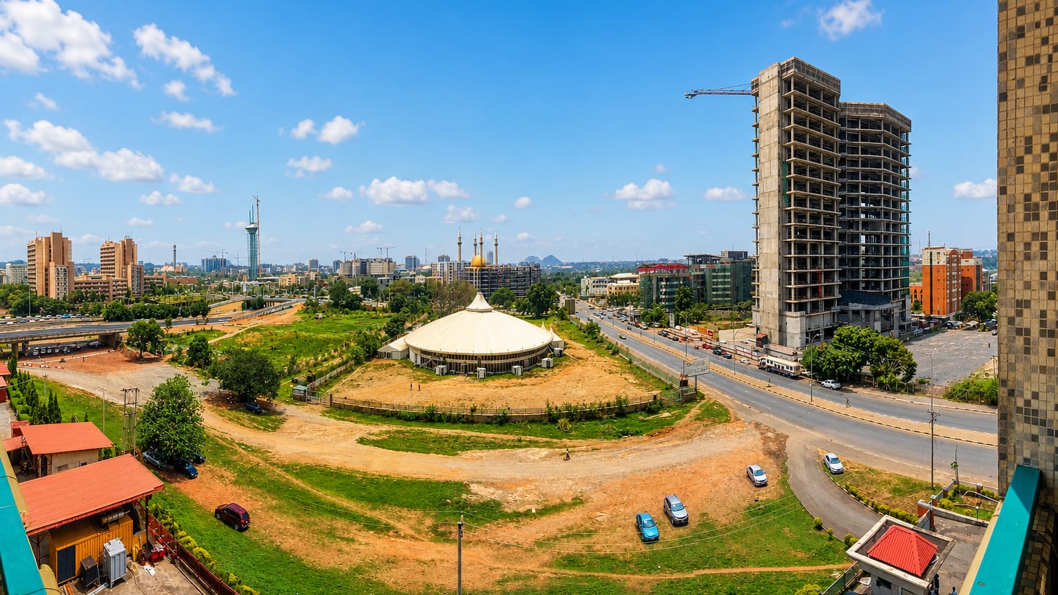 Abuja cityscape with the golden-domed National Mosque, a conical hall and high-rise towers under a blue sky.