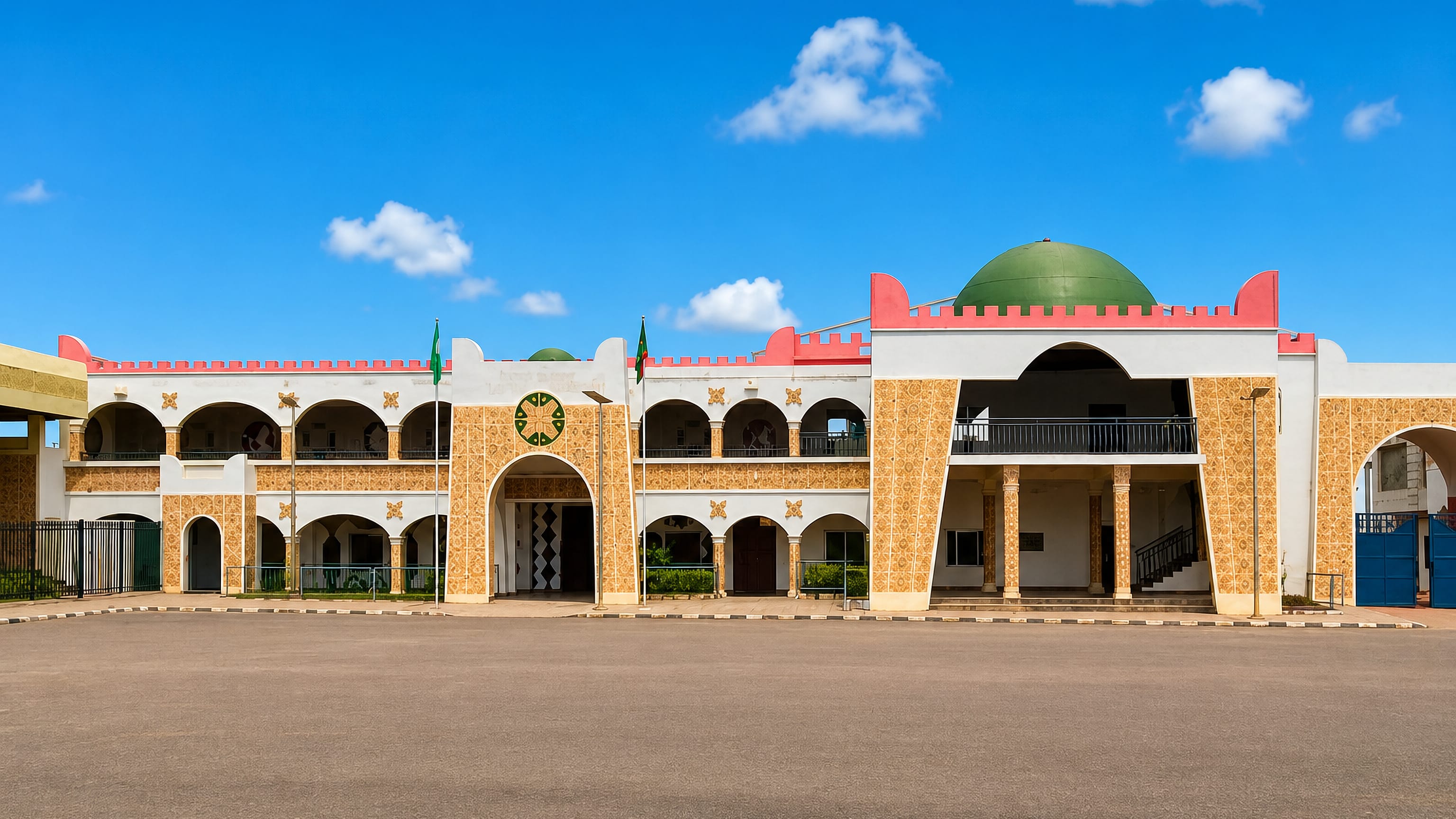 Ornate white and gold palace facade with a green dome and Nigerian flags in Lafia, Nasarawa State.